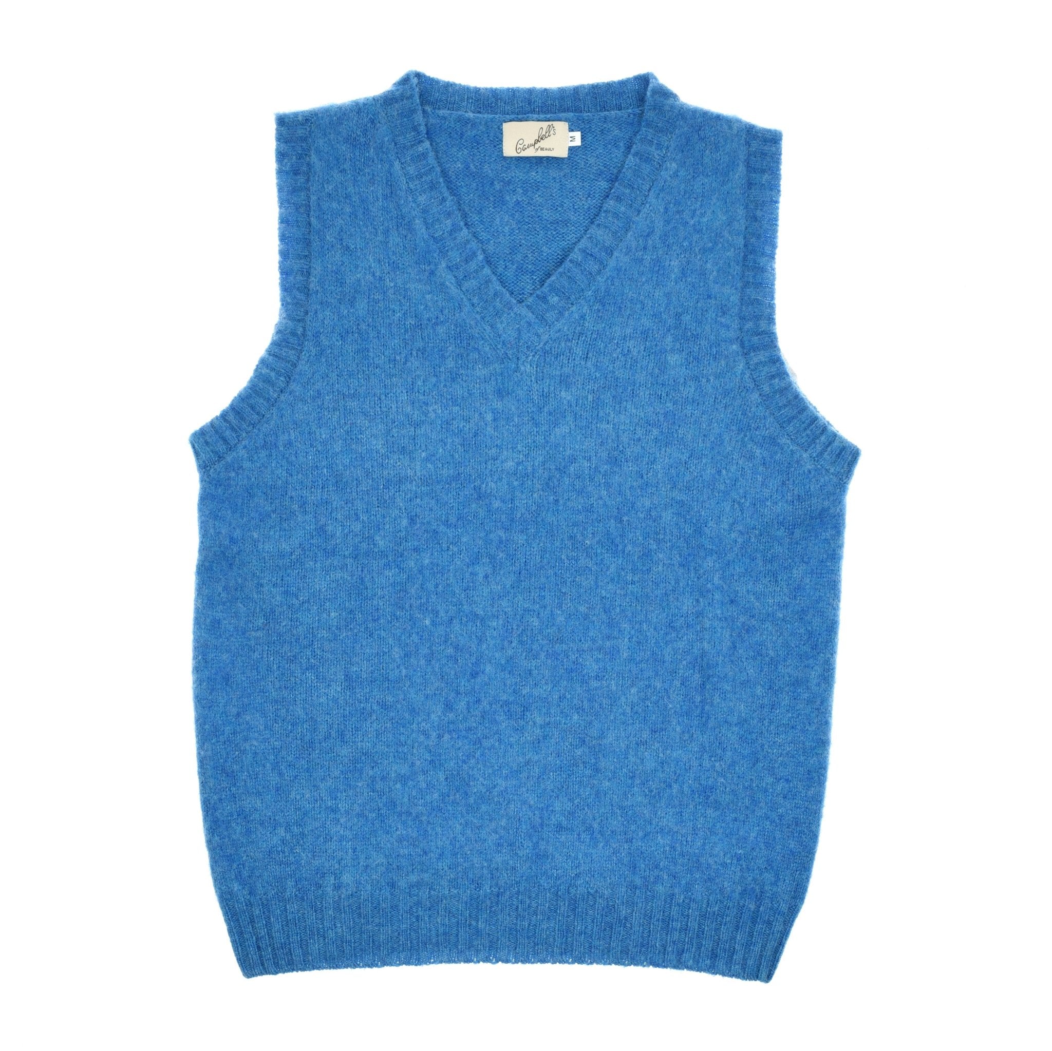 The Shetland Slipover by Campbells of Beauly is a sleeveless blue Shetland wool vest with a V-neck and ribbed hem, shown laid flat on a white background.