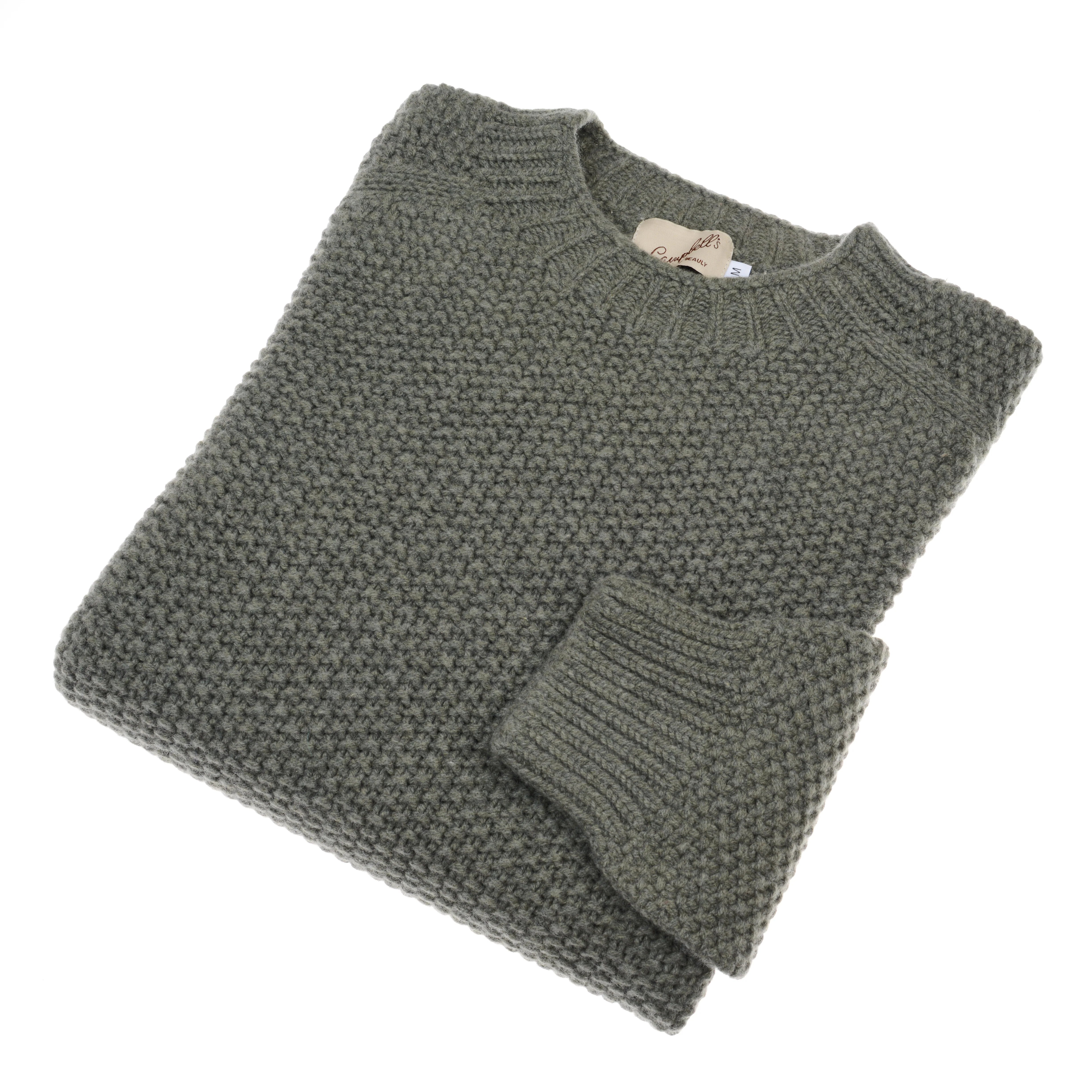 A neatly folded, chunky knit Moss Stitch Jumper by Campbell's of Beauly, in moss color with a ribbed collar and folded sleeve, displayed on a white background. This classic piece showcases timeless Scottish craftsmanship.