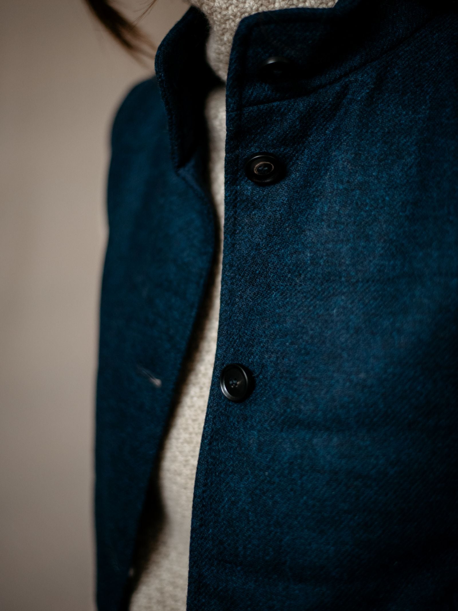 Close-up of a person wearing the Campbells of Beauly Quilted Buttoned Gilet over a light-colored textured turtleneck. The focus is on the gilet’s buttons and fabric; the persons face is not shown.