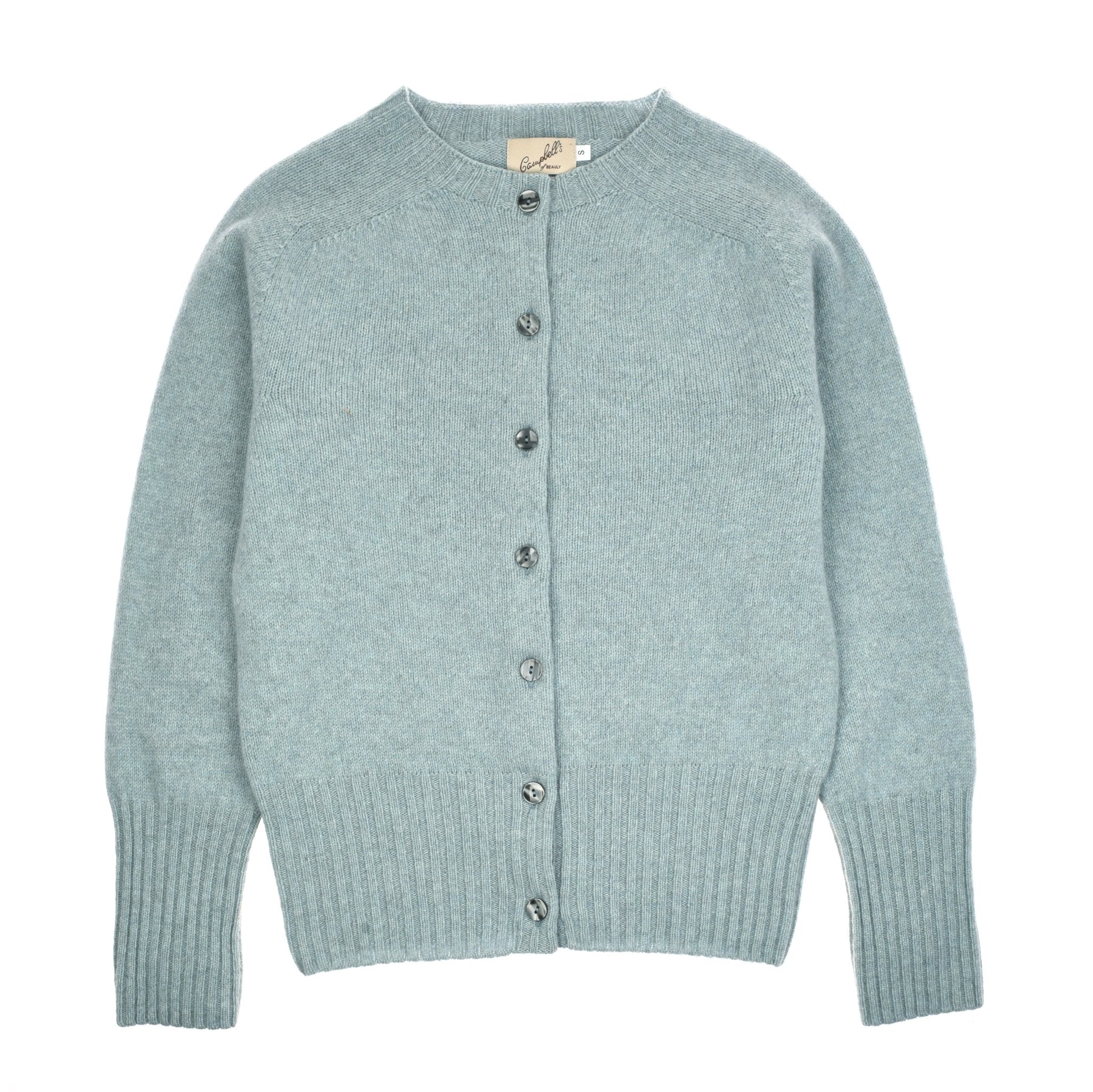 The Crew Cardigan by Campbells of Beauly in Skye is a light blue, Geelong lambswool piece with long sleeves, grey buttons, ribbed cuffs and hem, and a round neckline. Shown laid flat on a white background.