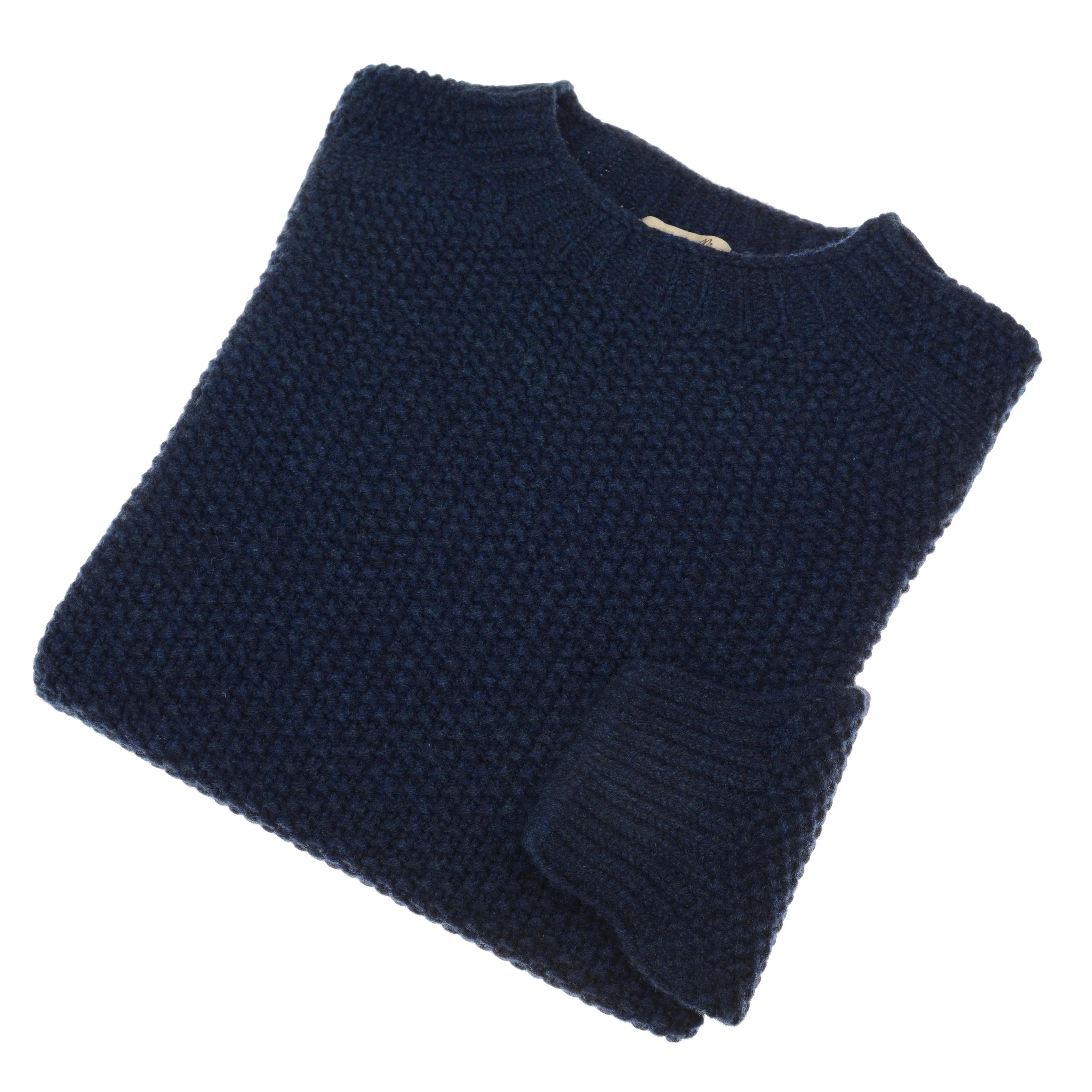 A neatly folded Campbells of Beauly Moss Stitch Jumper in Cosmos, featuring a textured pattern and knitted in Scotland, displayed on a white background.