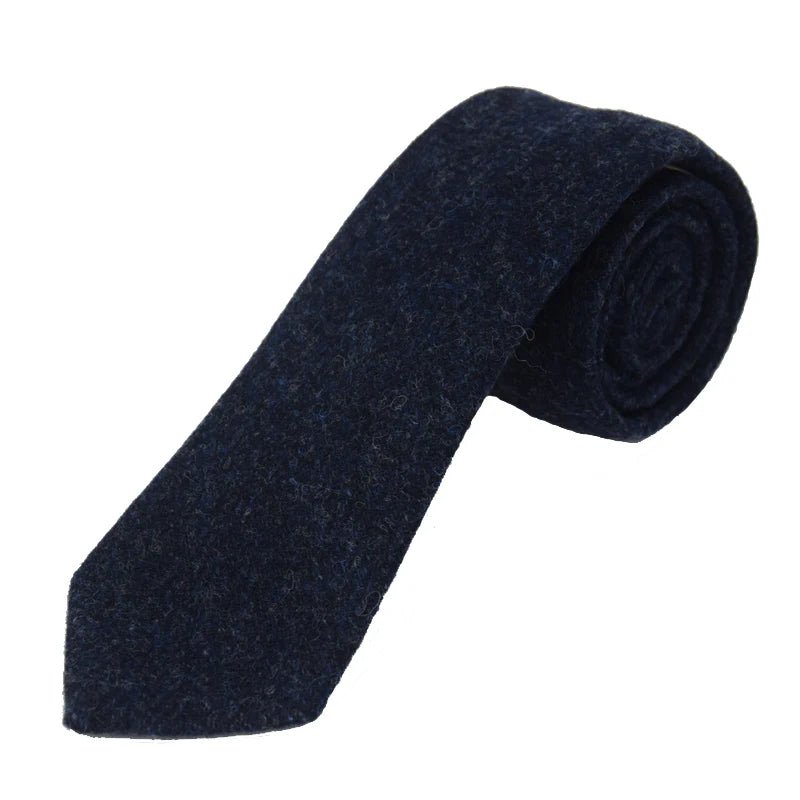A Campbells of Beauly Tweed Tie in navy, handmade with classic country styling, is rolled up and displayed on a white background.