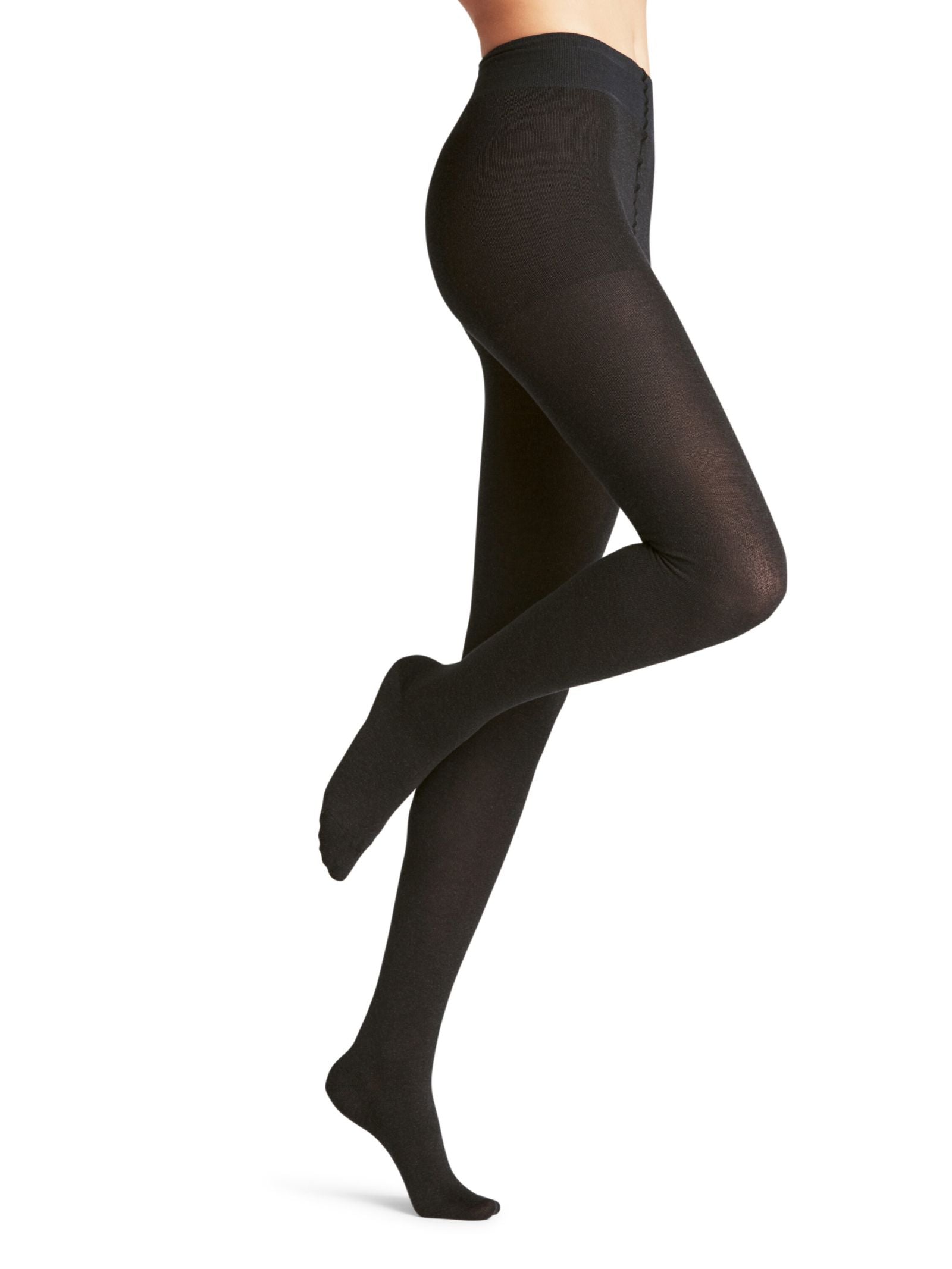 A person models FALKE Cotton Tights in opaque black, shown from midsection to feet with one leg bent and the other extended, against a white background.