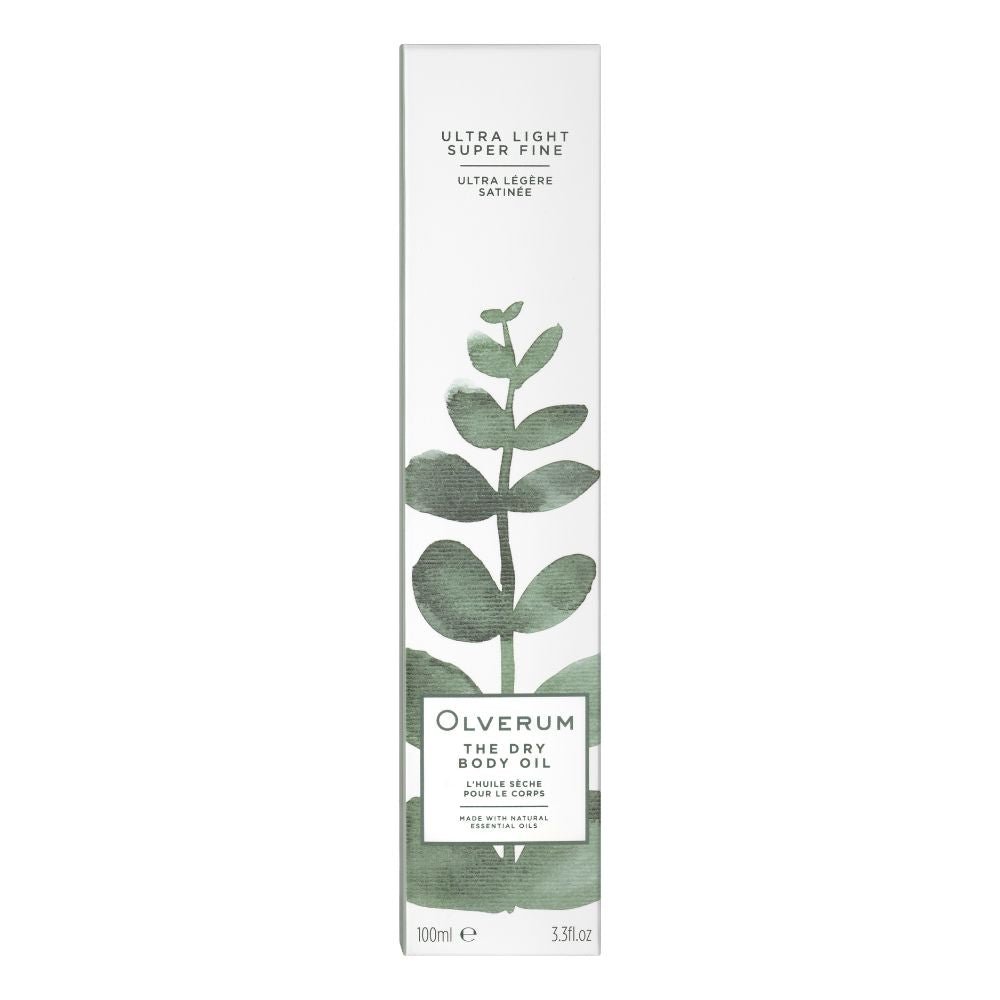 A tall, white rectangular box of Olverum Dry Body Oil with a green plant stem illustration. The packaging highlights botanical oils for hair and skin, an ultra-light super fine texture, and contains 100ml (3.3 fl oz).