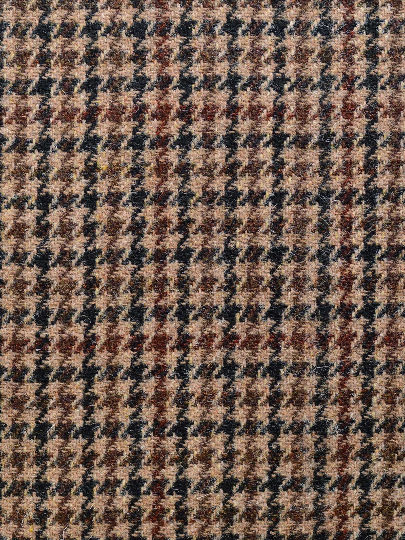 Close-up of Harris Tweed 93887 by Campbell's of Beauly, featuring a featherweight houndstooth pattern in brown, beige, and black tones with a textured woven surface inspired by Scottish weaving traditions.