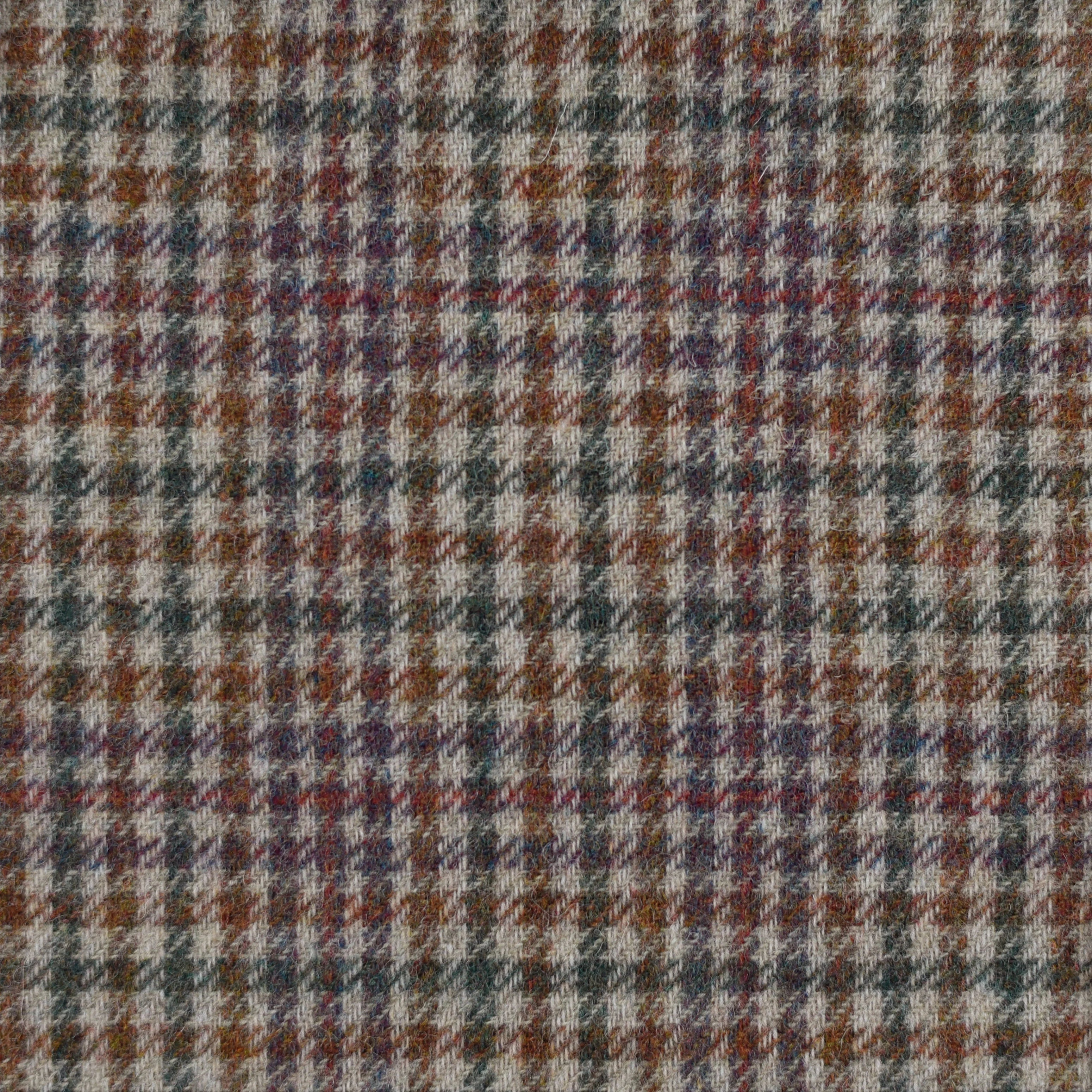A close-up of Campbells of Beauly House Tweed 11054, a lightweight Shetland wool fabric in brown, gray, and muted red houndstooth—showcasing Scottish textile heritage.