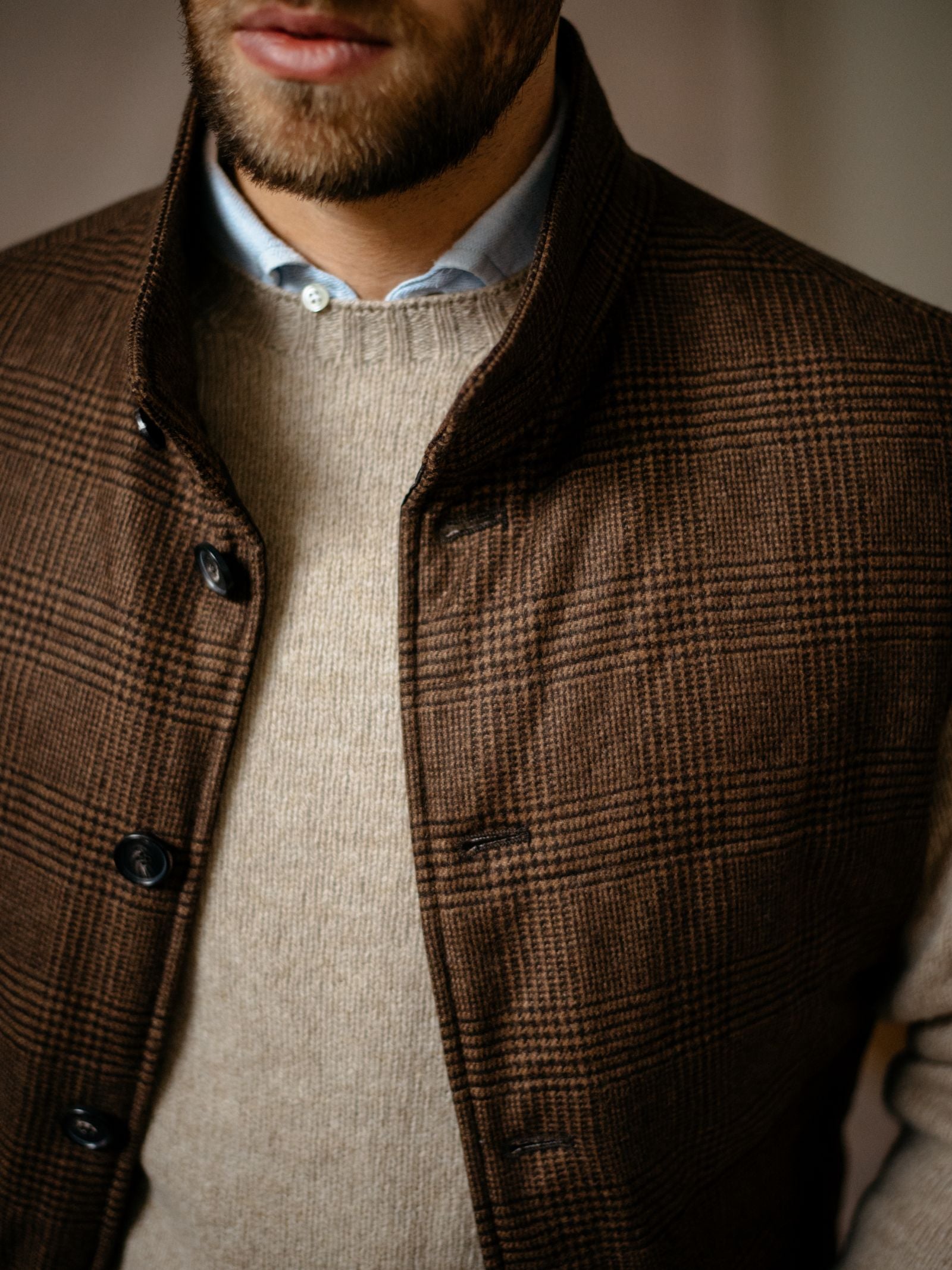 A close-up shows a man wearing Campbells of Beauly Cashmere Gun Club Quilted Gilet over a beige knit sweater and light blue shirt, with only the lower part of his face and upper torso visible—ideal for a refined country wardrobe.
