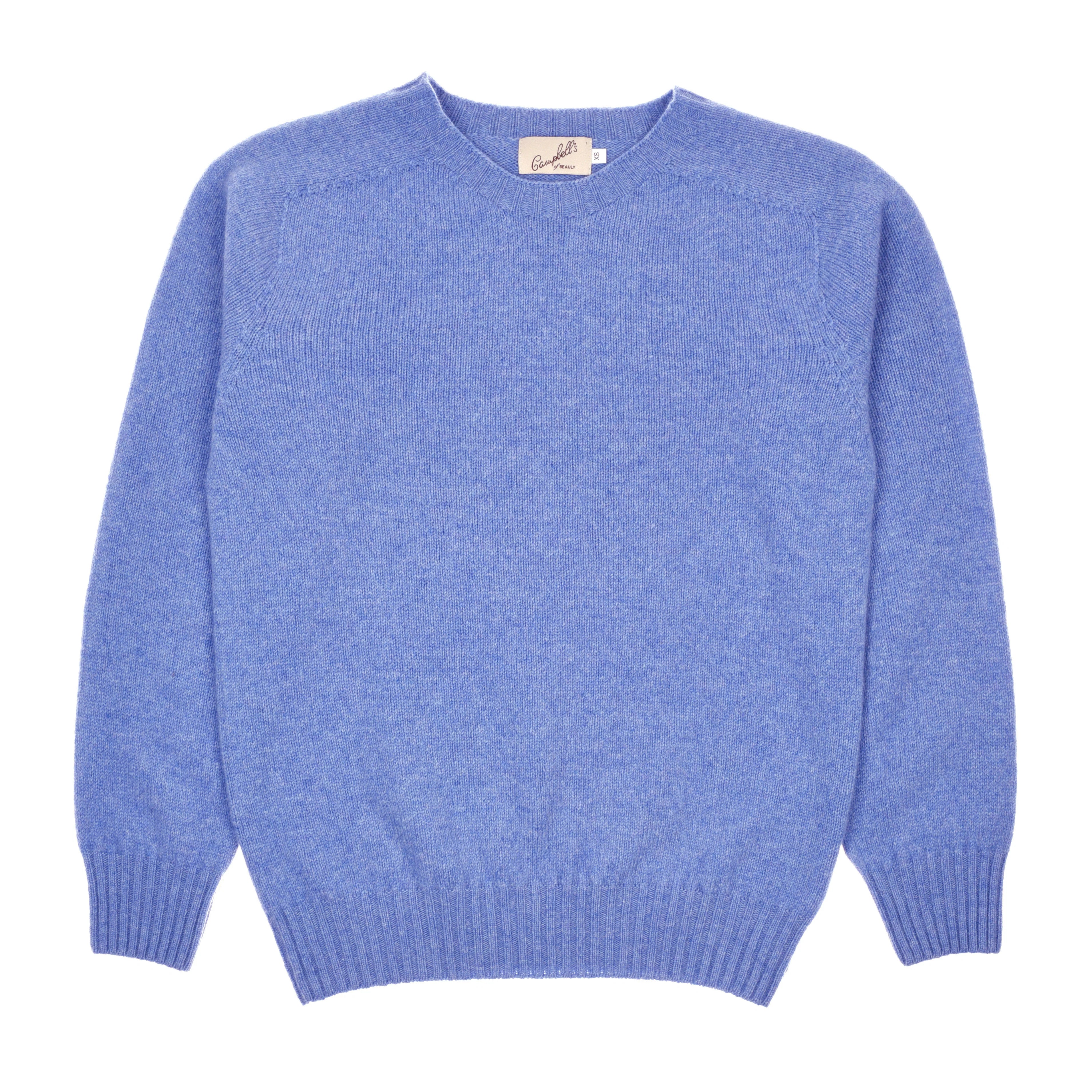 The Campbell's of Beauly Geelong Lambswool Crew Neck Jumper in Bluebell features long sleeves, ribbed cuffs and hem, and is made in Scotland from soft lambswool. Shown laid flat on a white background.