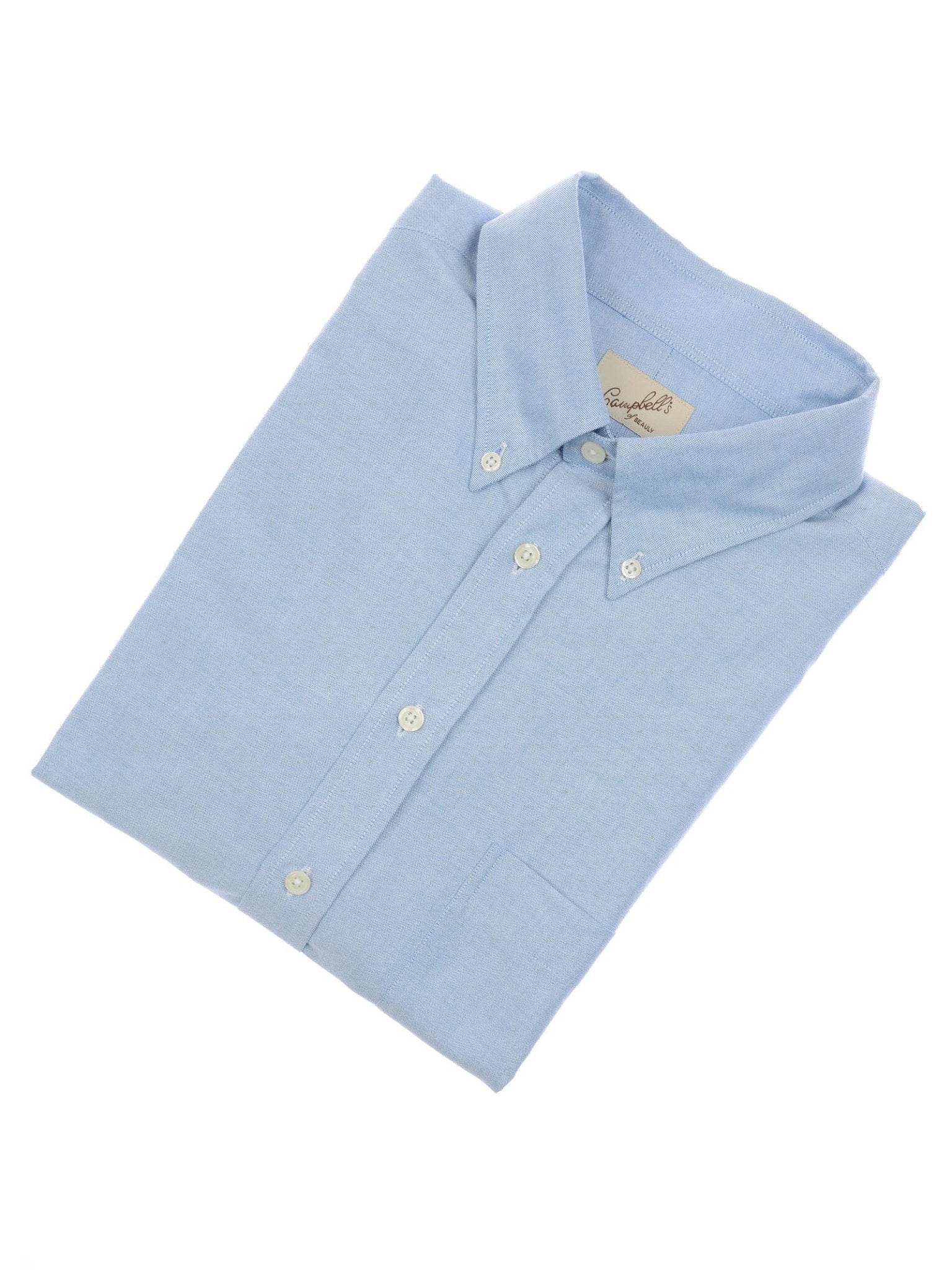 The Campbell's of Beauly Oxford Button Down Shirt, in light blue cotton with a front pocket and white buttons, is neatly folded and displayed on a plain white background.