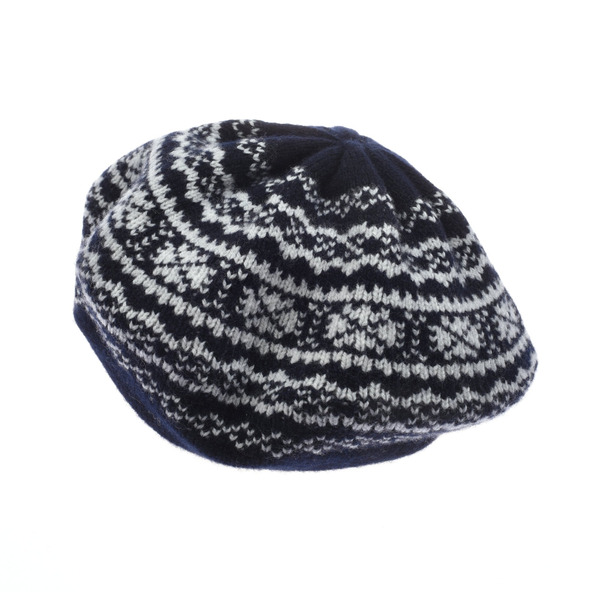 The Campbells of Beauly Two-Colour Fairisle Beret in navy features a geometric snowflake-inspired pattern and is displayed on a white background.