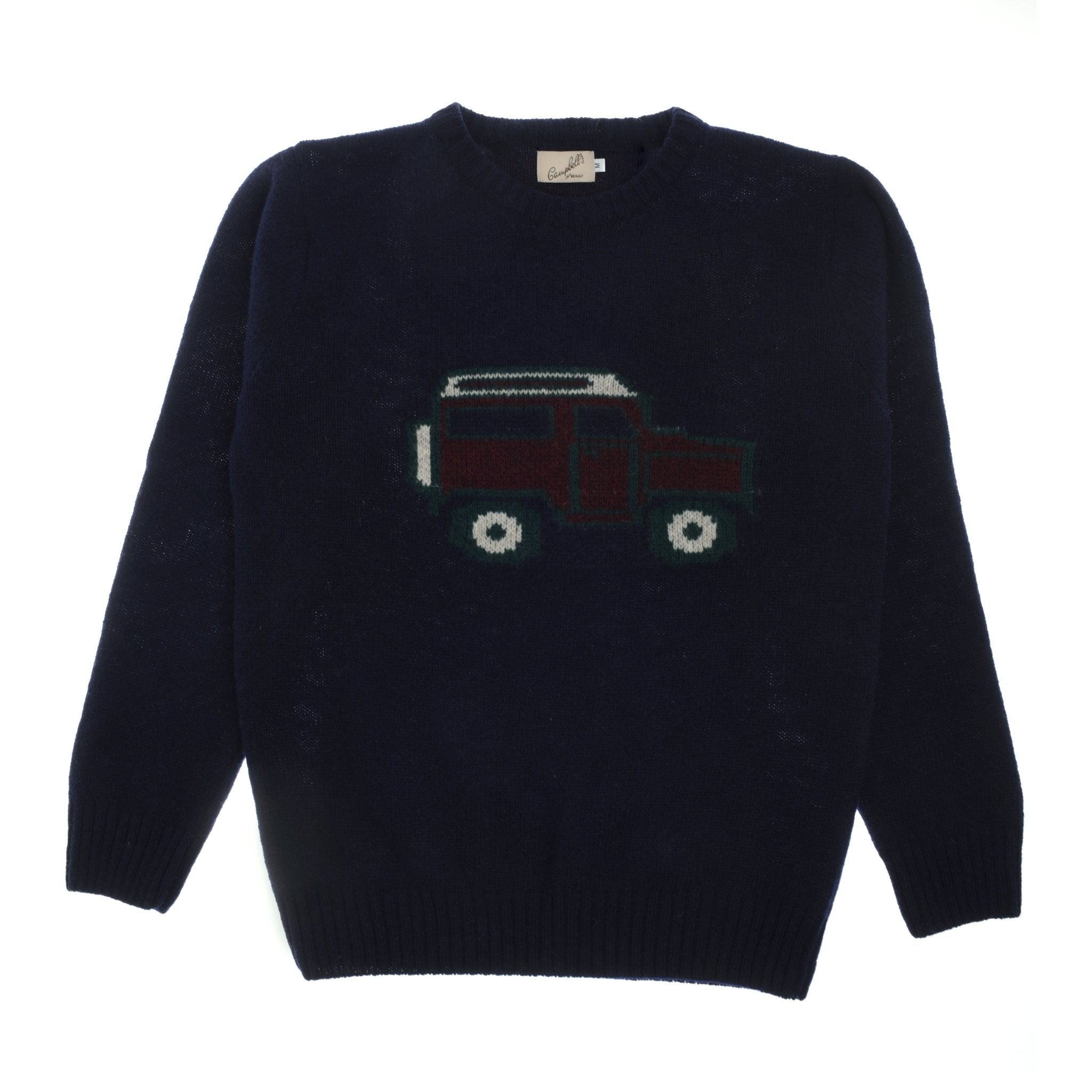 The Campbells of Beauly Land Rover Defender Jumper is a navy knit sweater with a classic Defender and white wheels on the front, finished with long sleeves and a round neckline—perfect for fans of timeless British motoring style.