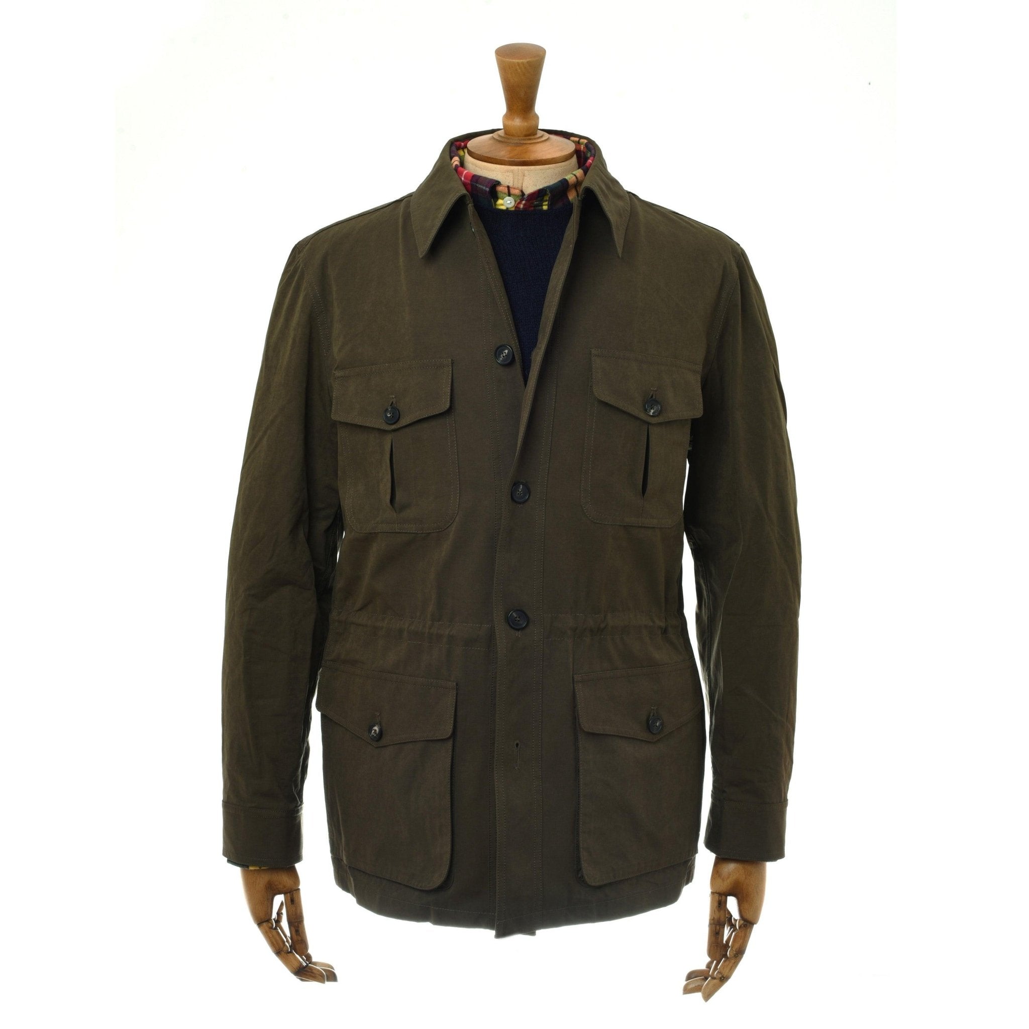 The Campbell’s of Beauly Aigas Field Jacket in olive features four front pockets, button closures, and a collar. Made from water-repellent peach skin fabric, it’s shown on a wooden mannequin against a white background.