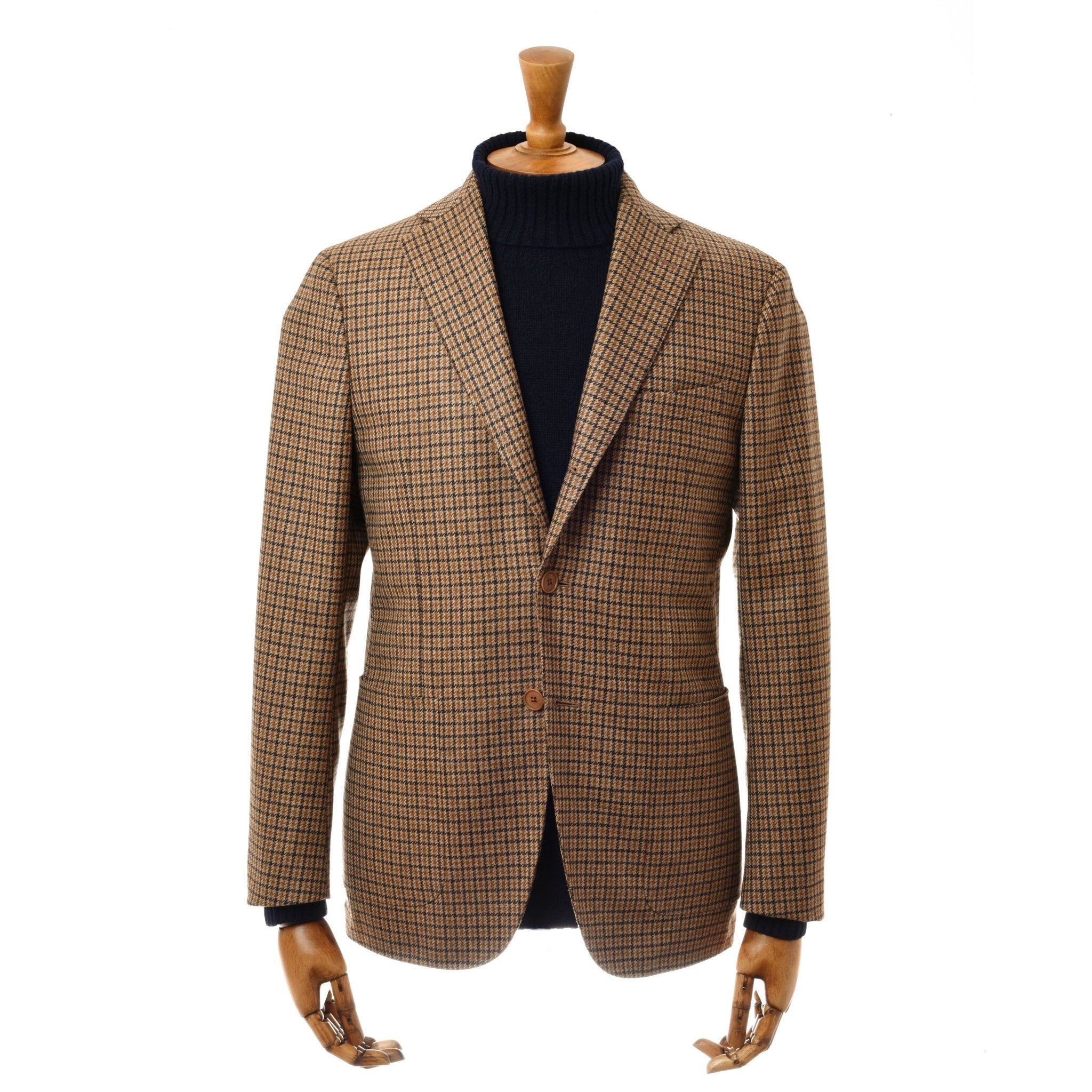 A Campbells of Beauly Gun Club Jacket in brown plaid, regular fit with two buttons, is shown on a wooden mannequin wearing a black turtleneck sweater against a plain white backdrop.