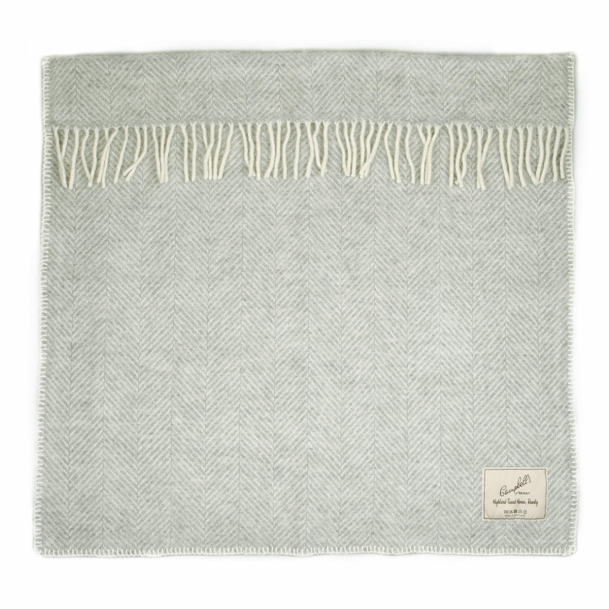 The Campbells of Beauly Baby Blanket in silver features a subtle herringbone pattern, cream fringe, and a sewn label on the bottom right. Shown neatly on a white background, it provides soft comfort for your baby all year round.