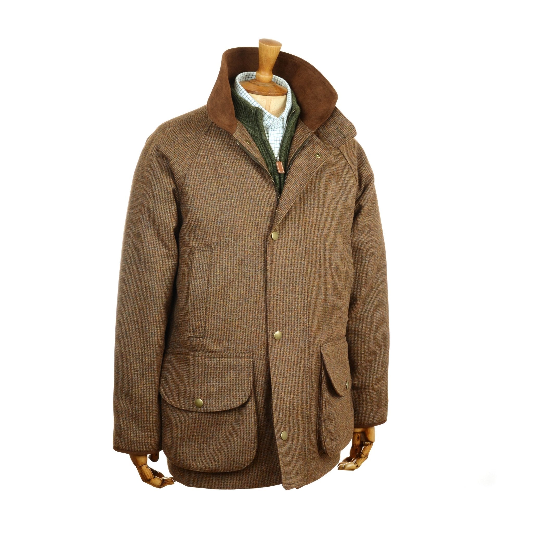 The Campbells of Beauly Tweed Field Coat in brown features a high Alcantara collar, button and zip front, large front pockets, and a green inner layer, shown here on a wooden mannequin torso.