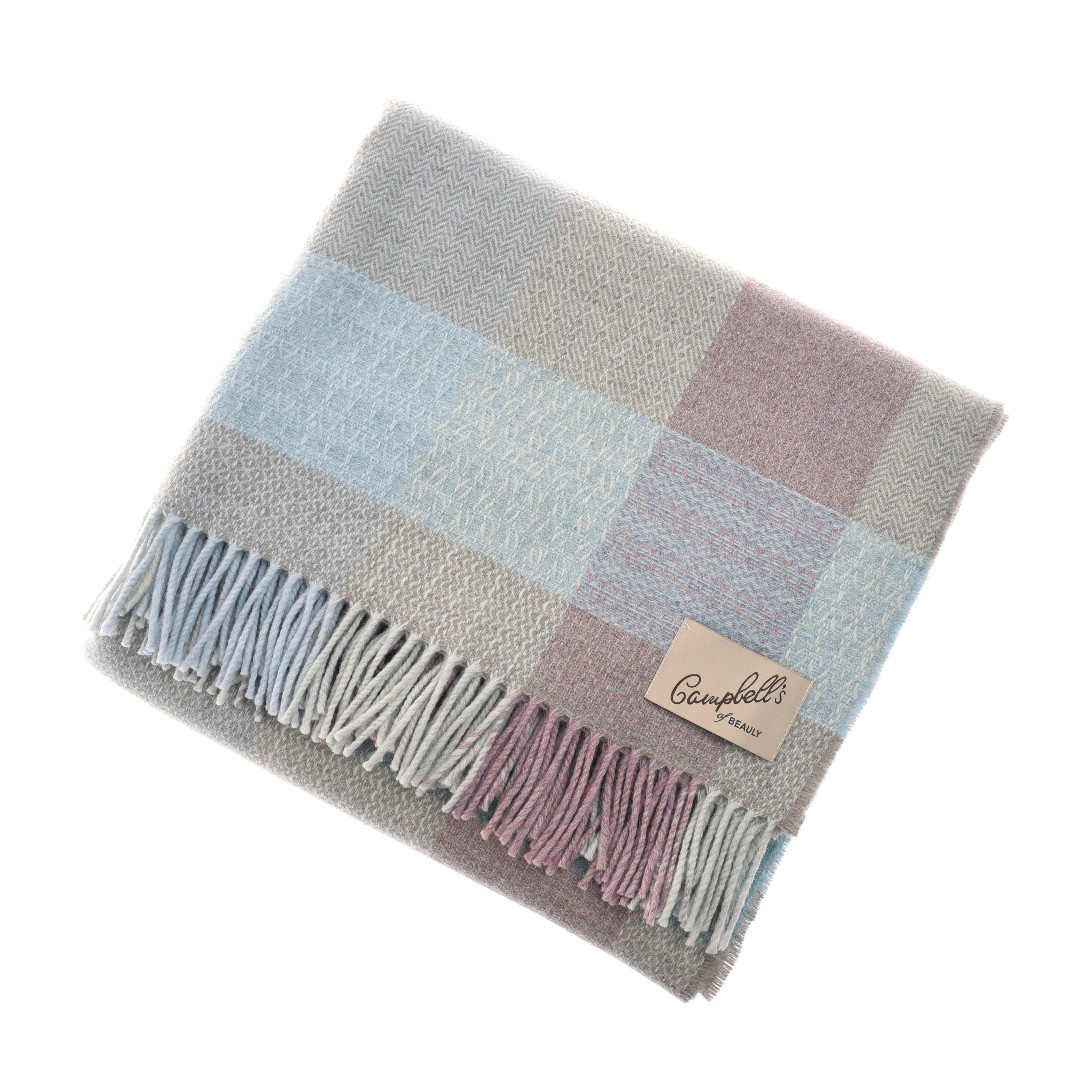 A folded Patchwork Throw by Campbells of Beauly in pastel plaid—soft blue, grey, and mauve—with fringed edges and a sewn brown brand label, woven using traditional techniques. Displayed on a white background.