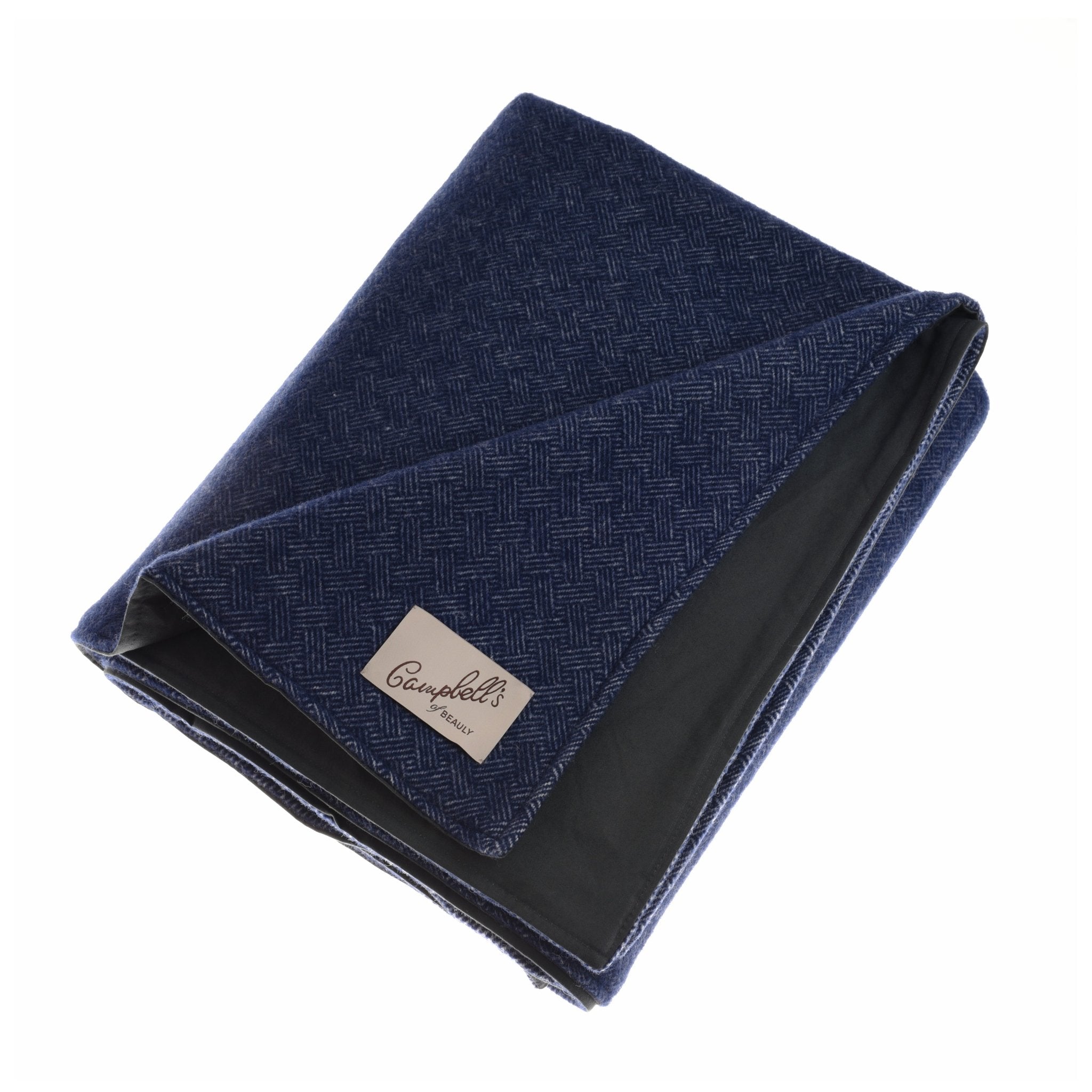 A folded navy Waterproof Picnic Blanket by Campbells of Beauly, featuring a beige label and subtle herringbone pattern, displayed on a white background.