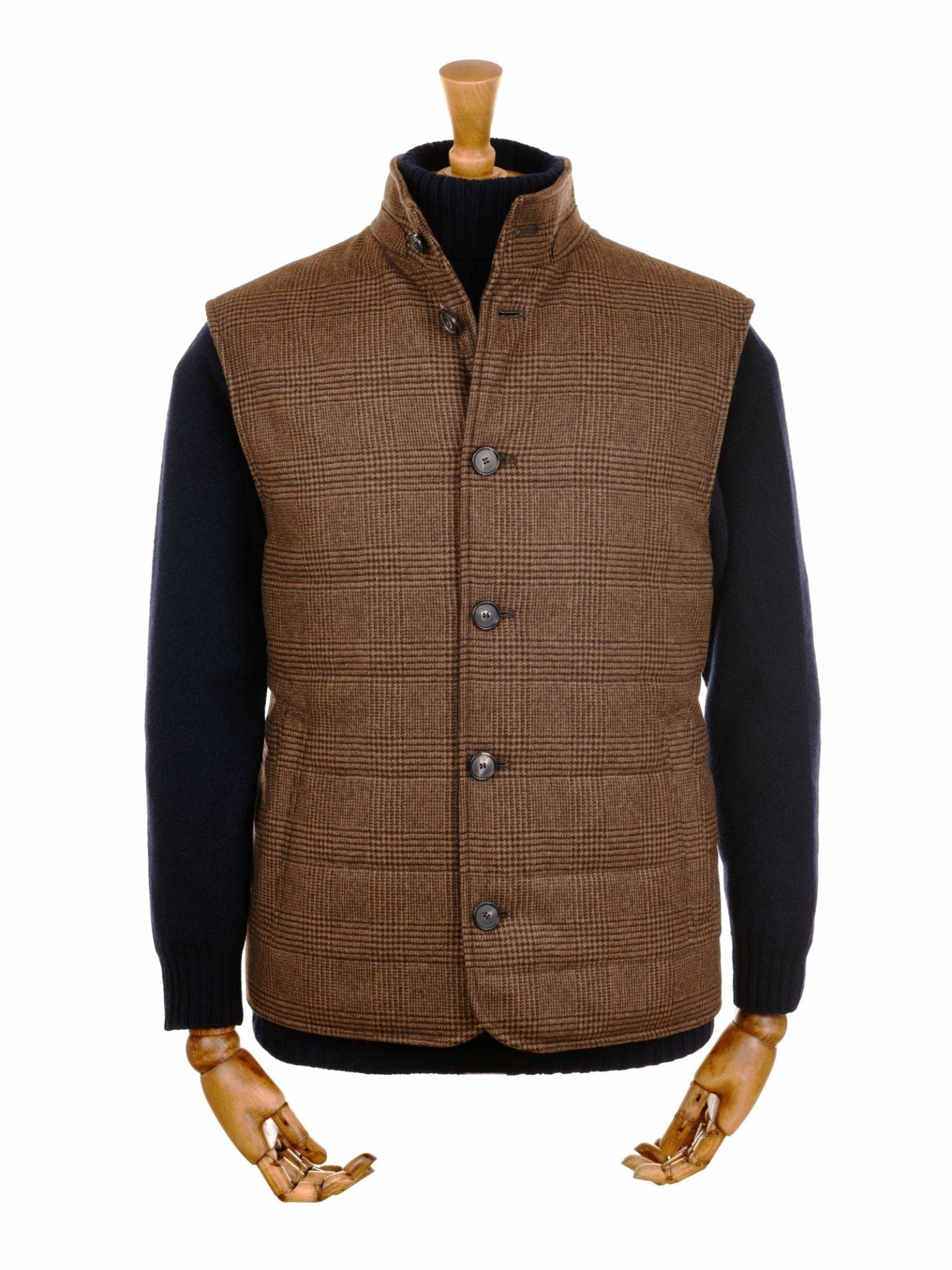 A mannequin with wooden hands displays the Campbells of Beauly Cashmere Gun Club Quilted Gilet in chocolate over a black long-sleeve sweater, evoking classic country style; face and lower body are not visible.
