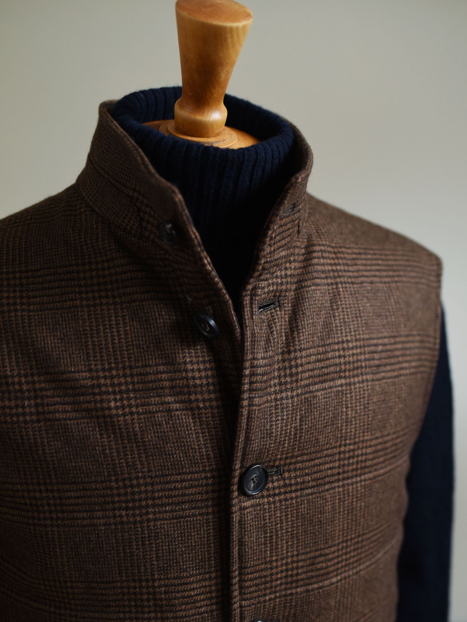 A close-up of the Campbells of Beauly Cashmere Gun Club Quilted Gilet on a mannequin over a dark navy turtleneck, set against a neutral background.