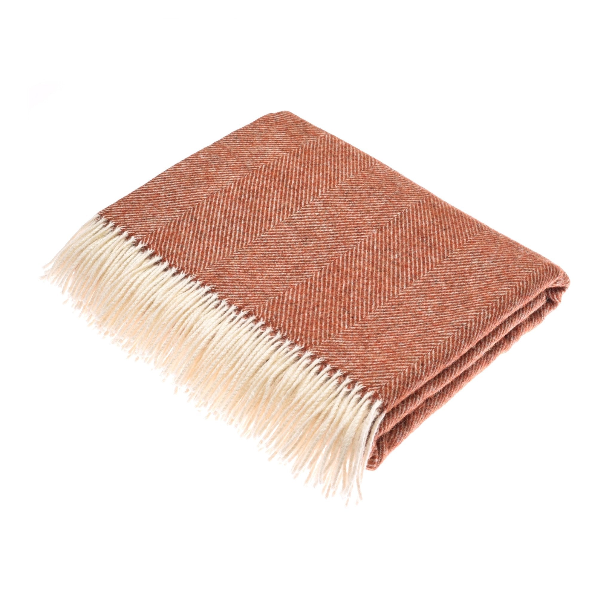 The Campbells of Beauly Herringbone Lambswool Blanket in brick red features a subtle herringbone pattern and a cream fringe on one end, shown folded against a white background.