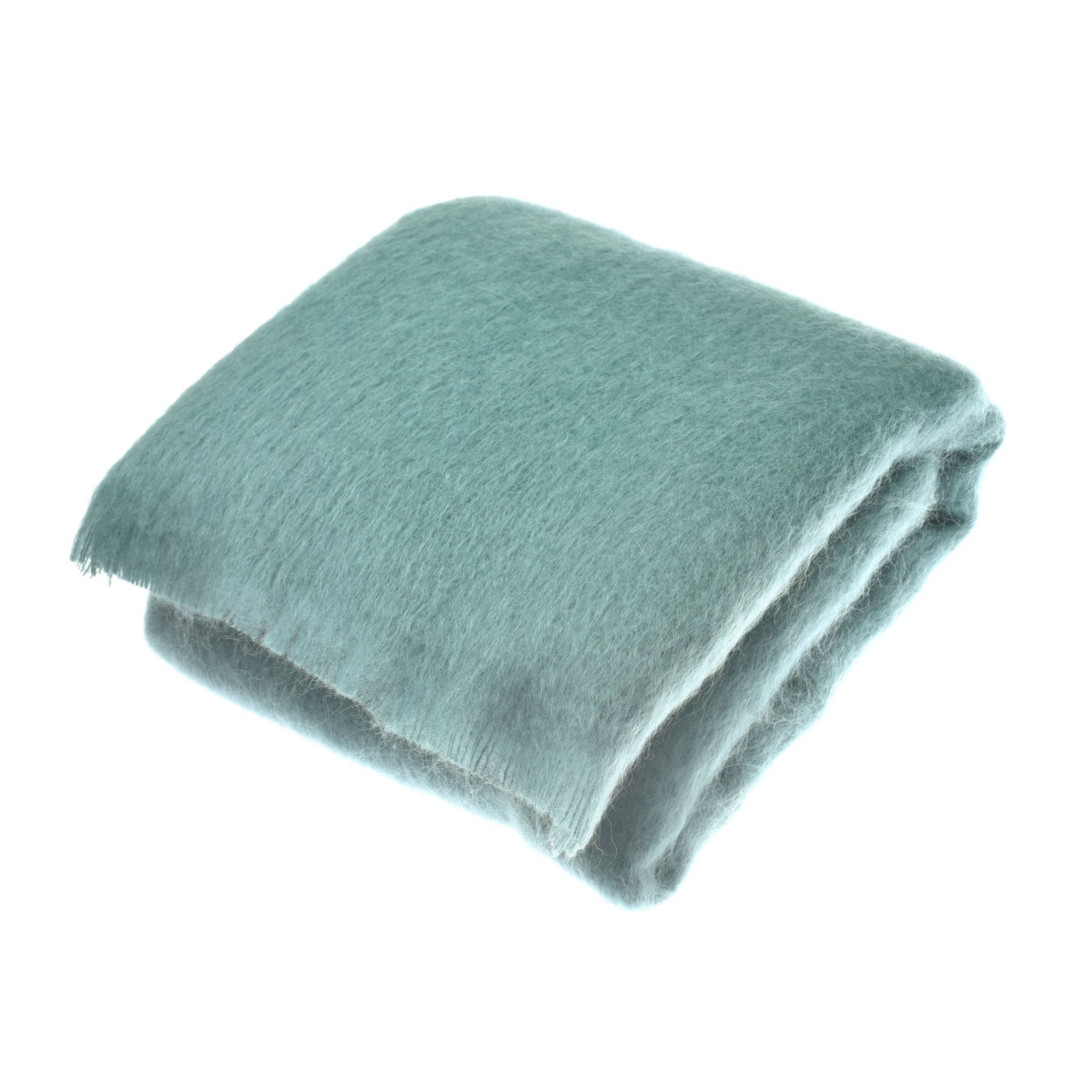 A folded, soft Mohair Throw in Juniper by Campbells of Beauly, with a slightly fuzzy texture, adds a luxurious layer—displayed on a white background and crafted in Yorkshire.