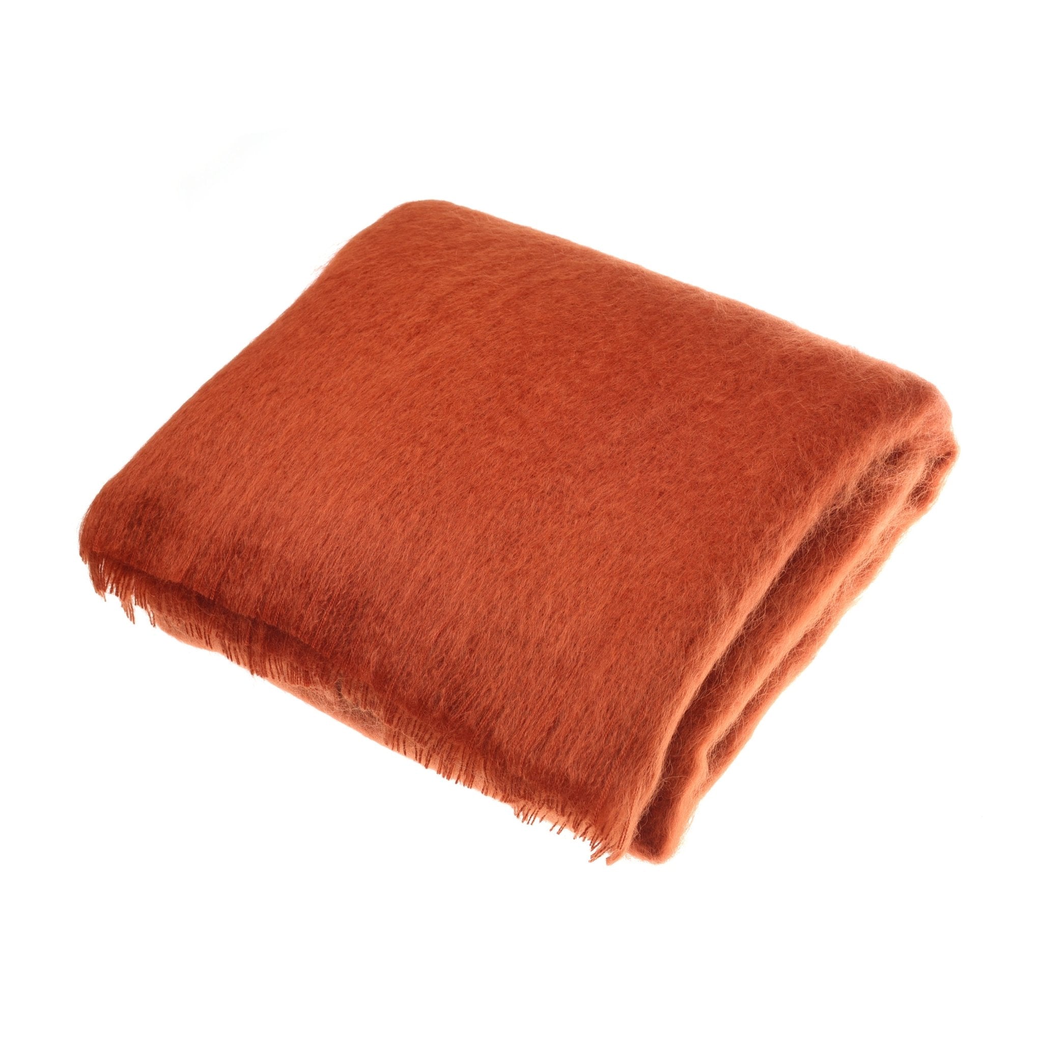 A folded, fluffy Campbells of Beauly Mohair Throw in Lacquer Red with a soft, fuzzy texture is shown on a plain white background—an elegant, luxurious layer for any space.