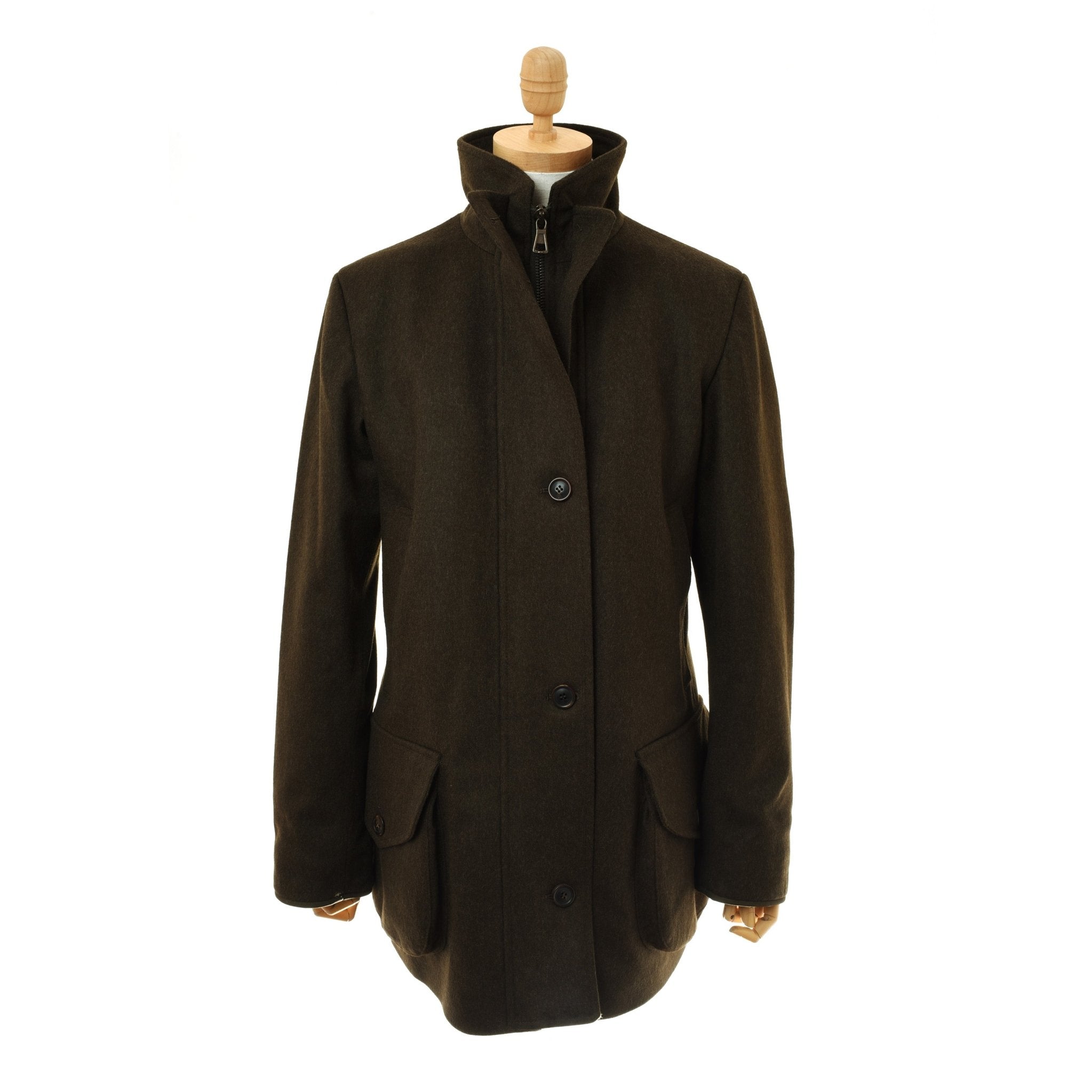 The Loden Green Field Coat by Campbells of Beauly, made from Austrian Loden fabric, features a high collar, front pockets, and tailored fit. Displayed on a wooden mannequin against a white background, it’s timeless outerwear.