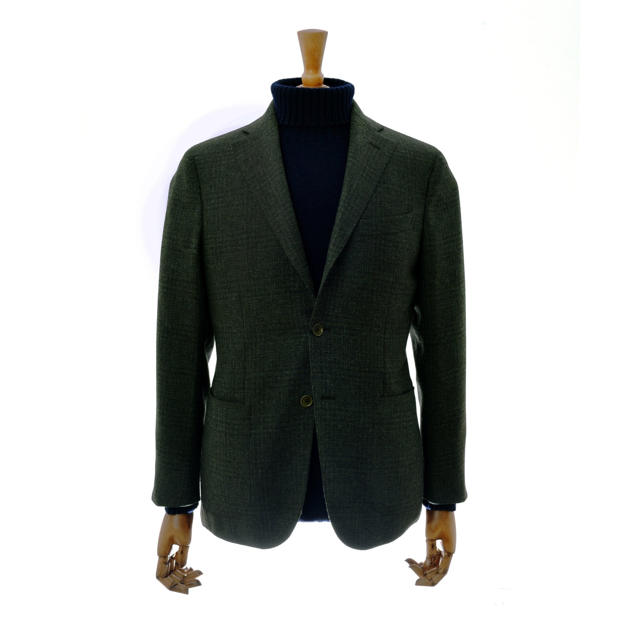 The Glen Check Jacket by Campbells of Beauly, in green, is displayed on a mannequin with wooden hands over a black turtleneck sweater, highlighting classic tailoring against a plain white background.