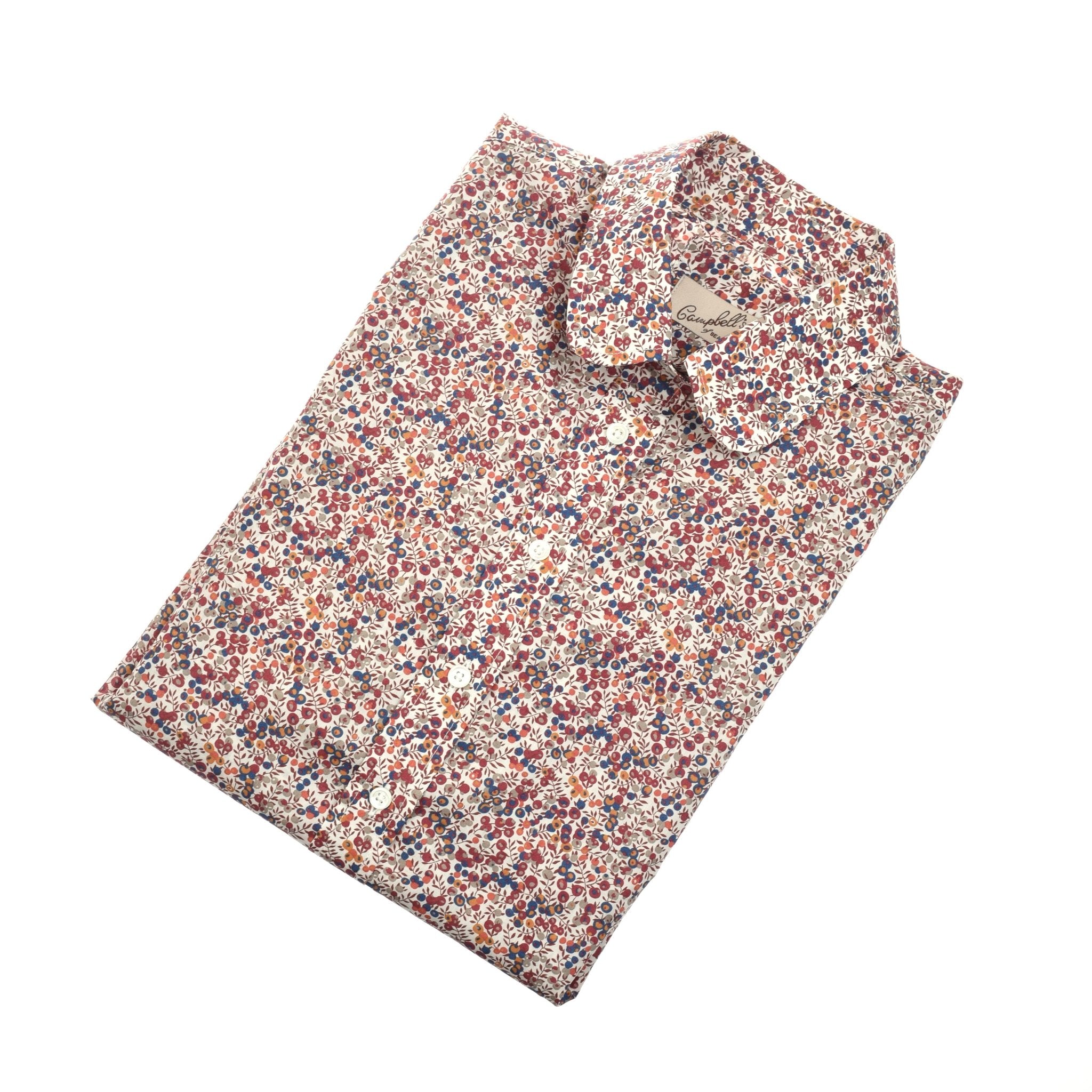 A folded Liberty Print Cotton Shirt by Campbells of Beauly, made from soft Tana Lawn cotton, showcases a red, blue, and beige small floral print on white, displayed on a white surface.