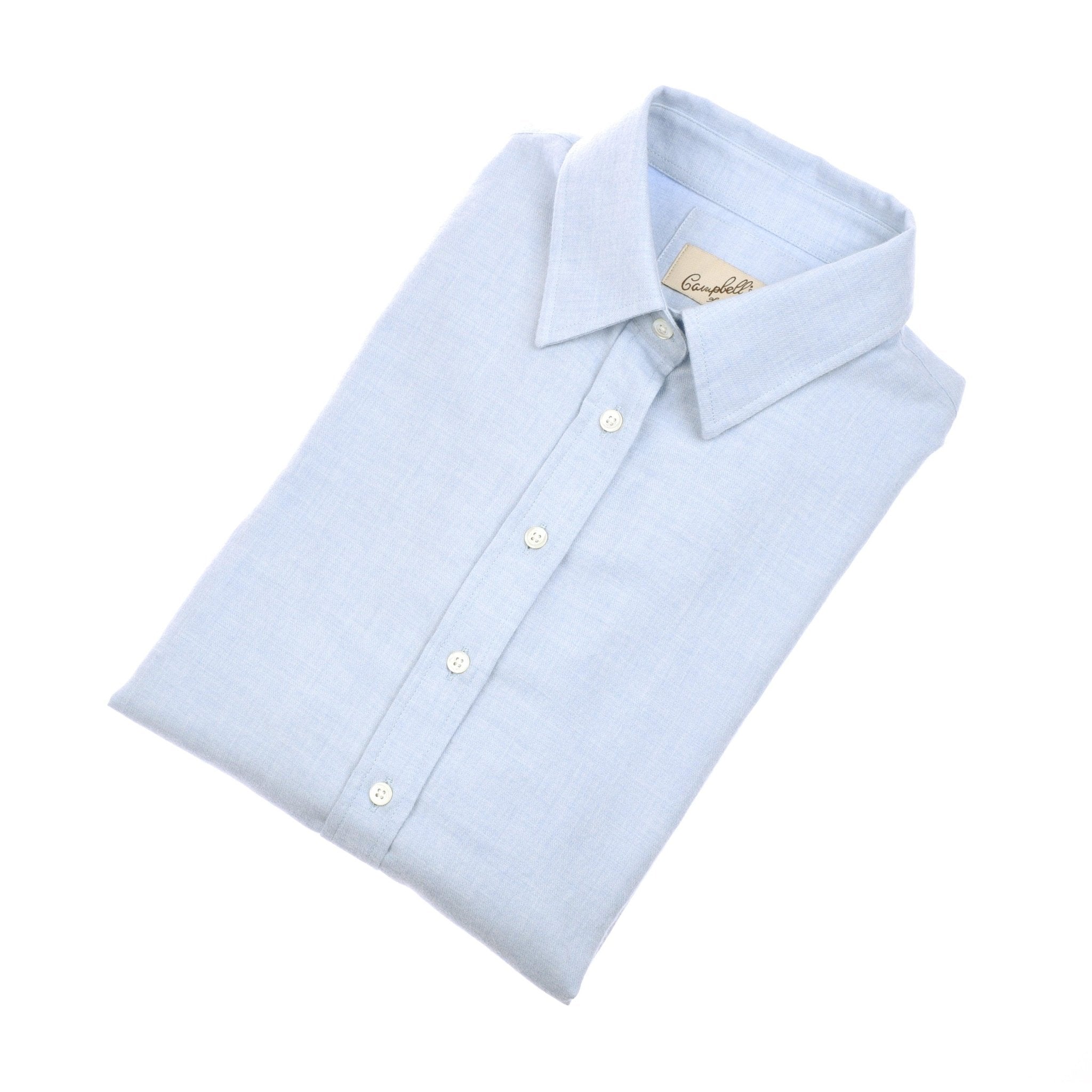 The Campbells of Beauly Brushed Cotton Shirt in blue features a classic fit, long sleeves, white buttons, and a smart collar—neatly folded on a white background—a timeless and versatile wardrobe essential.