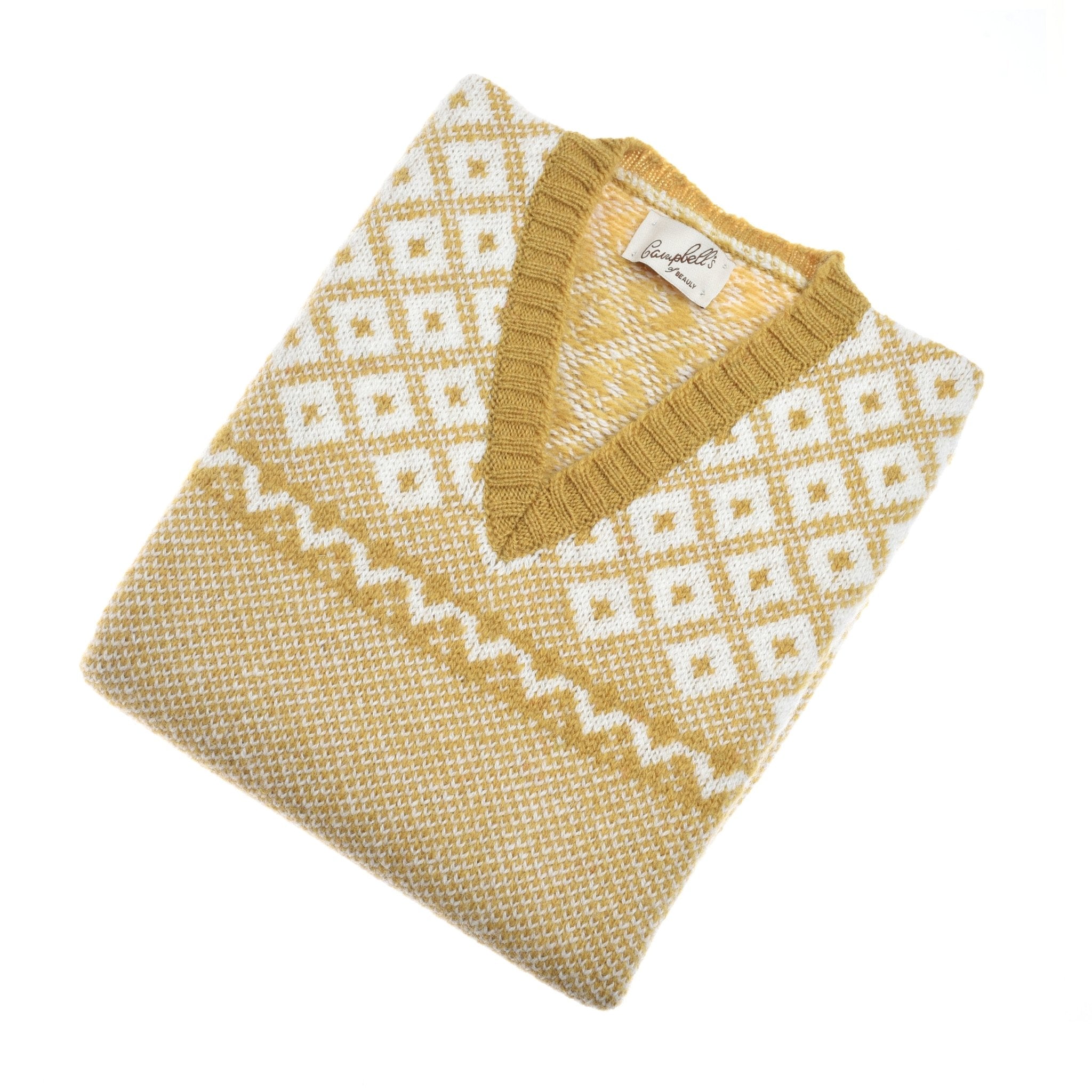 The Campbells of Beauly Nordic V Tank is a gold and white V-neck slipover with a diamond pattern and ribbed collar, crafted from soft Shetland wool and shown folded on a white background.