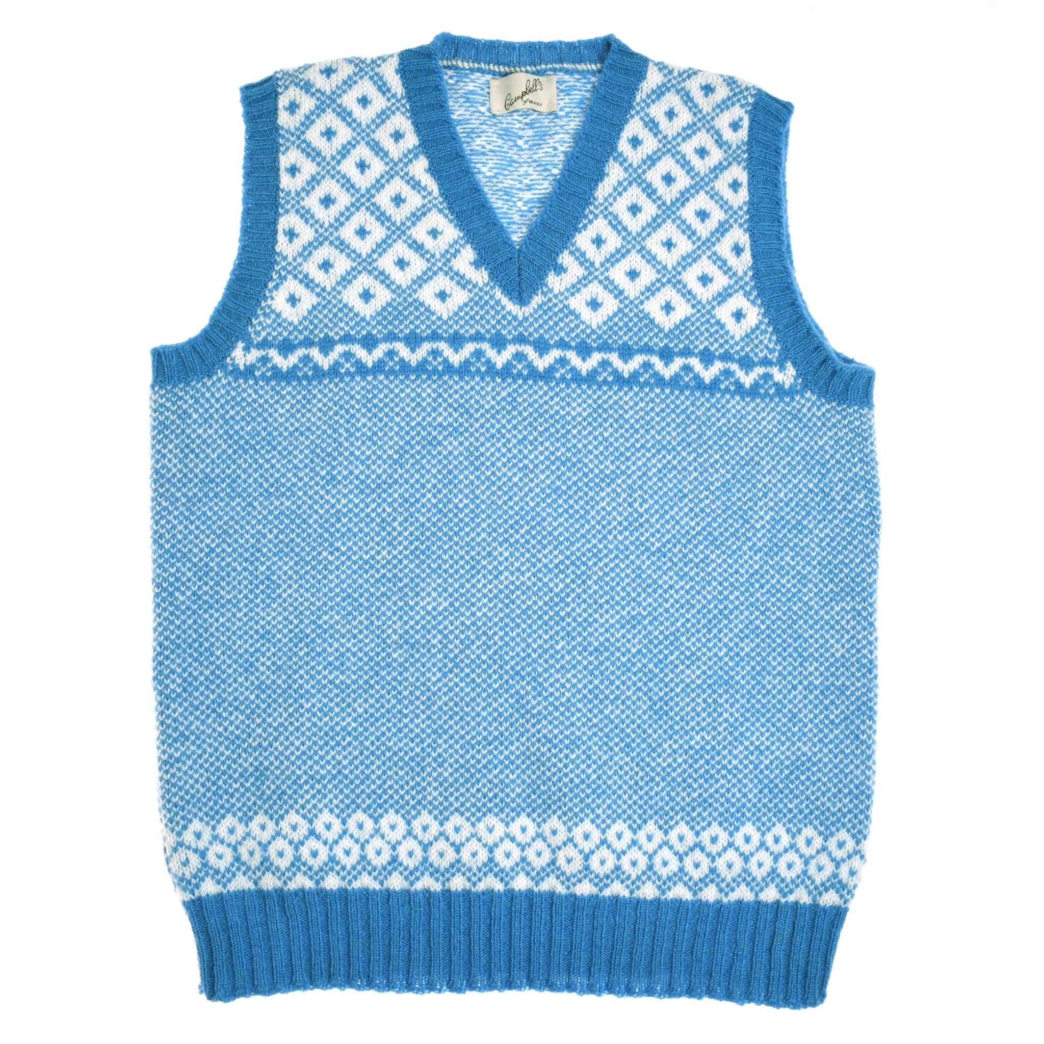 The Nordic V Tank by Campbells of Beauly is a bluebell knitted V-neck vest crafted from soft Shetland wool, featuring a white geometric and diamond Fair Isle pattern at the chest and hem plus classic ribbed edges.