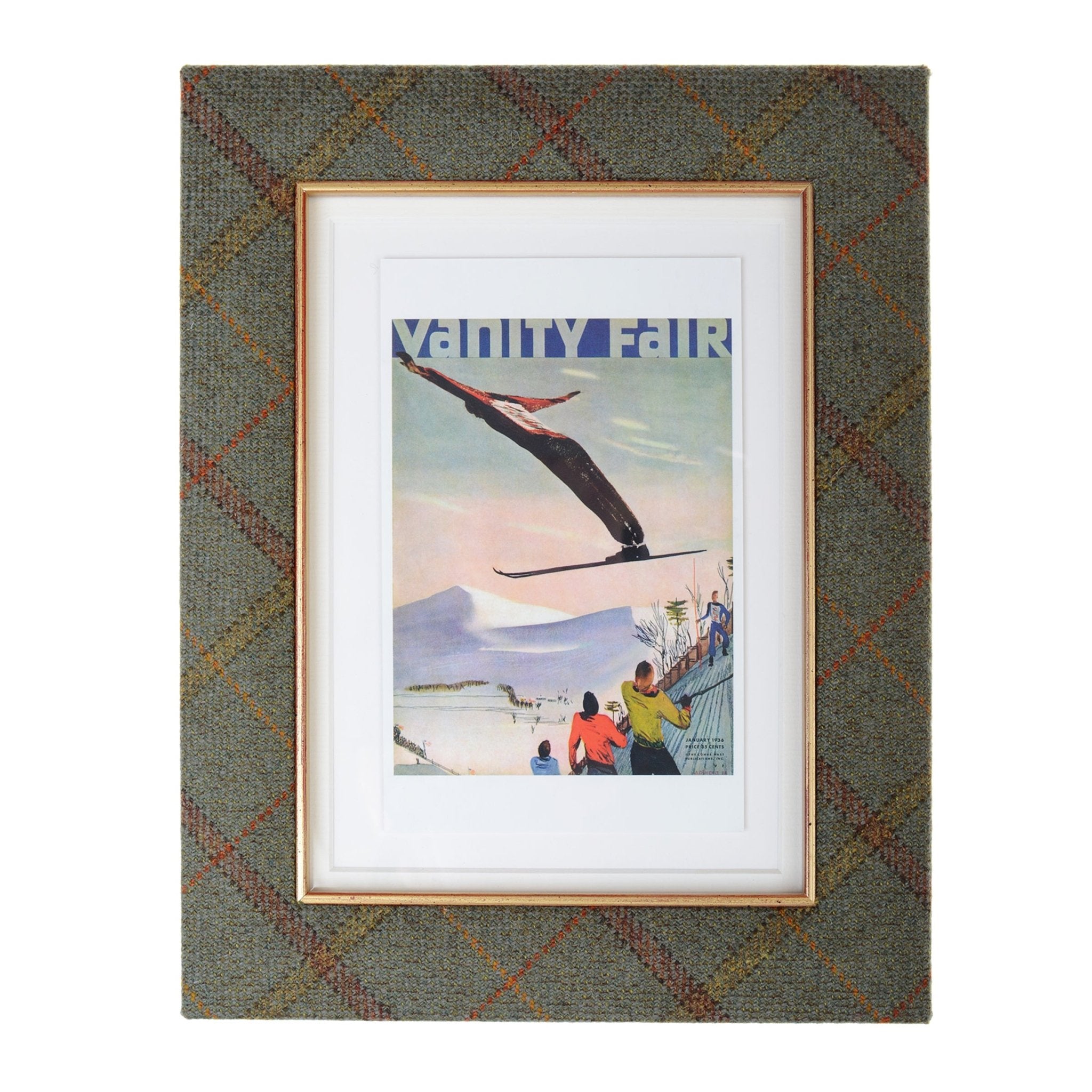 The Campbells of Beauly Tweed Photoframe displays a Vanity Fair ski jumper illustration, with spectators and snowy mountains, framed in classic plaid tweed for timeless country charm.