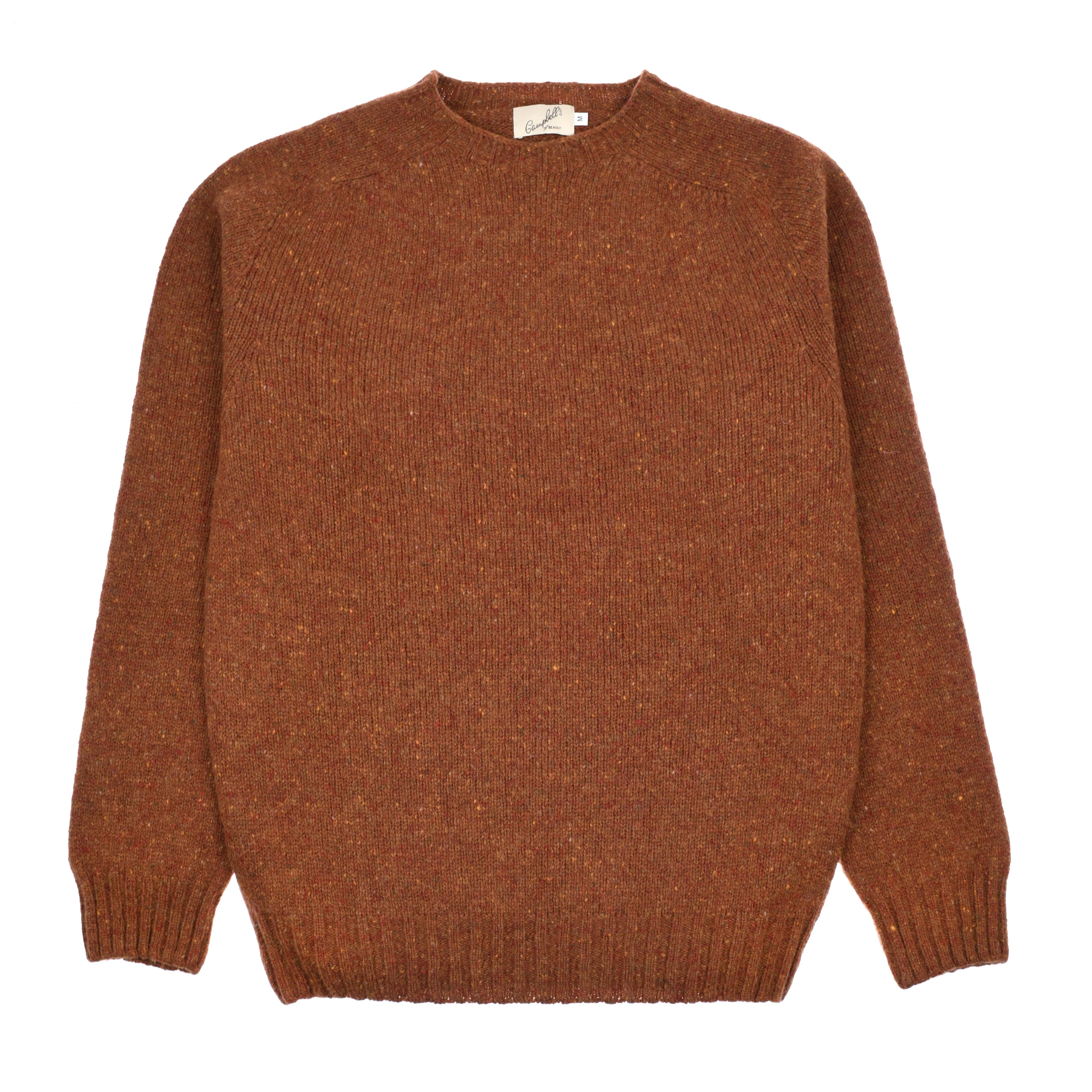 A brown Donegal Lambswool Crew Neck Jumper by Campbells of Beauly, featuring a signature flecked texture, ribbed cuffs, hem, and neckline. The sweater is laid flat with a white tag visible inside the collar.