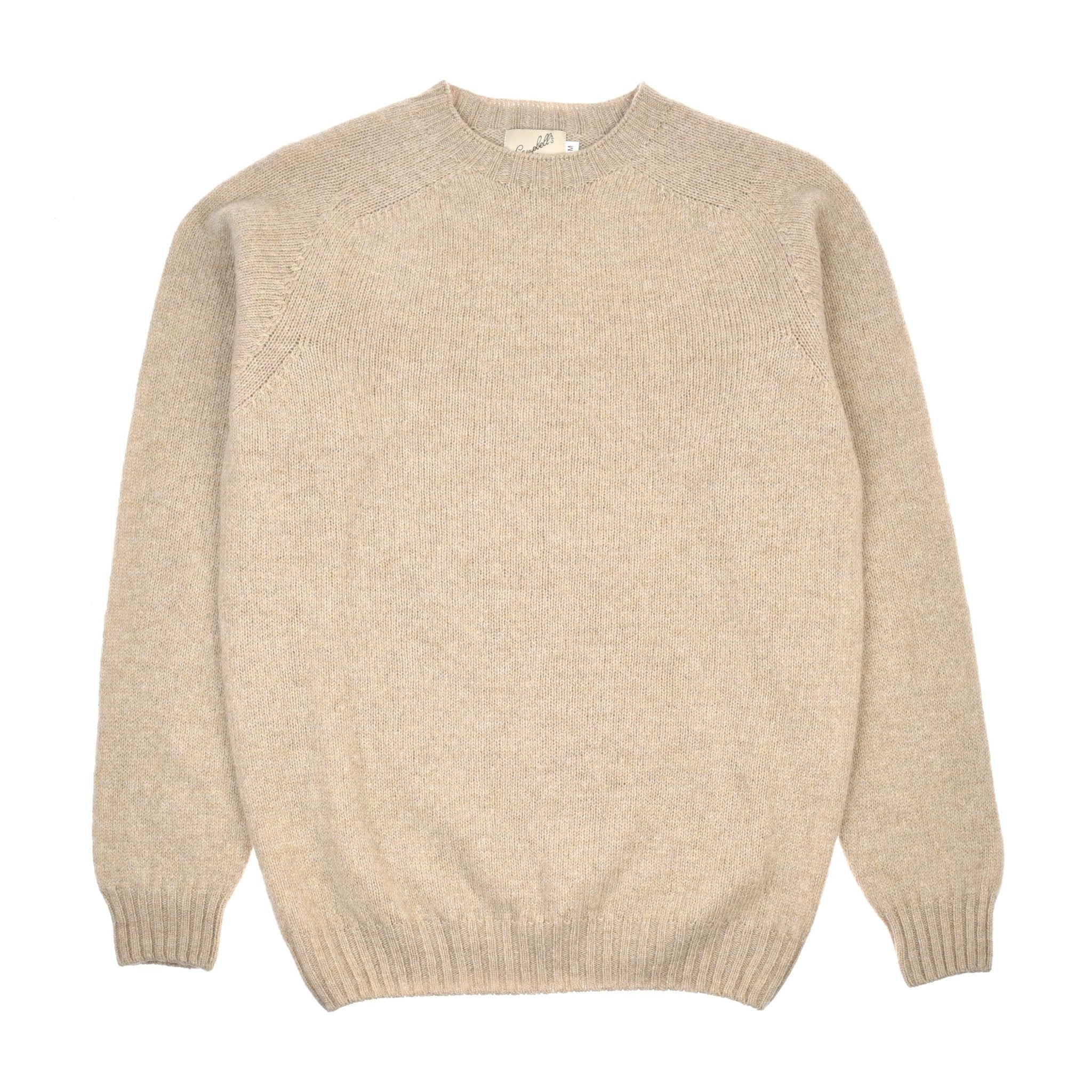 The Campbells of Beauly Shetland Jumper in beige, crafted from soft lambswool with a crew neck, long sleeves, and ribbed cuffs and hem, is shown laid flat on a white background.