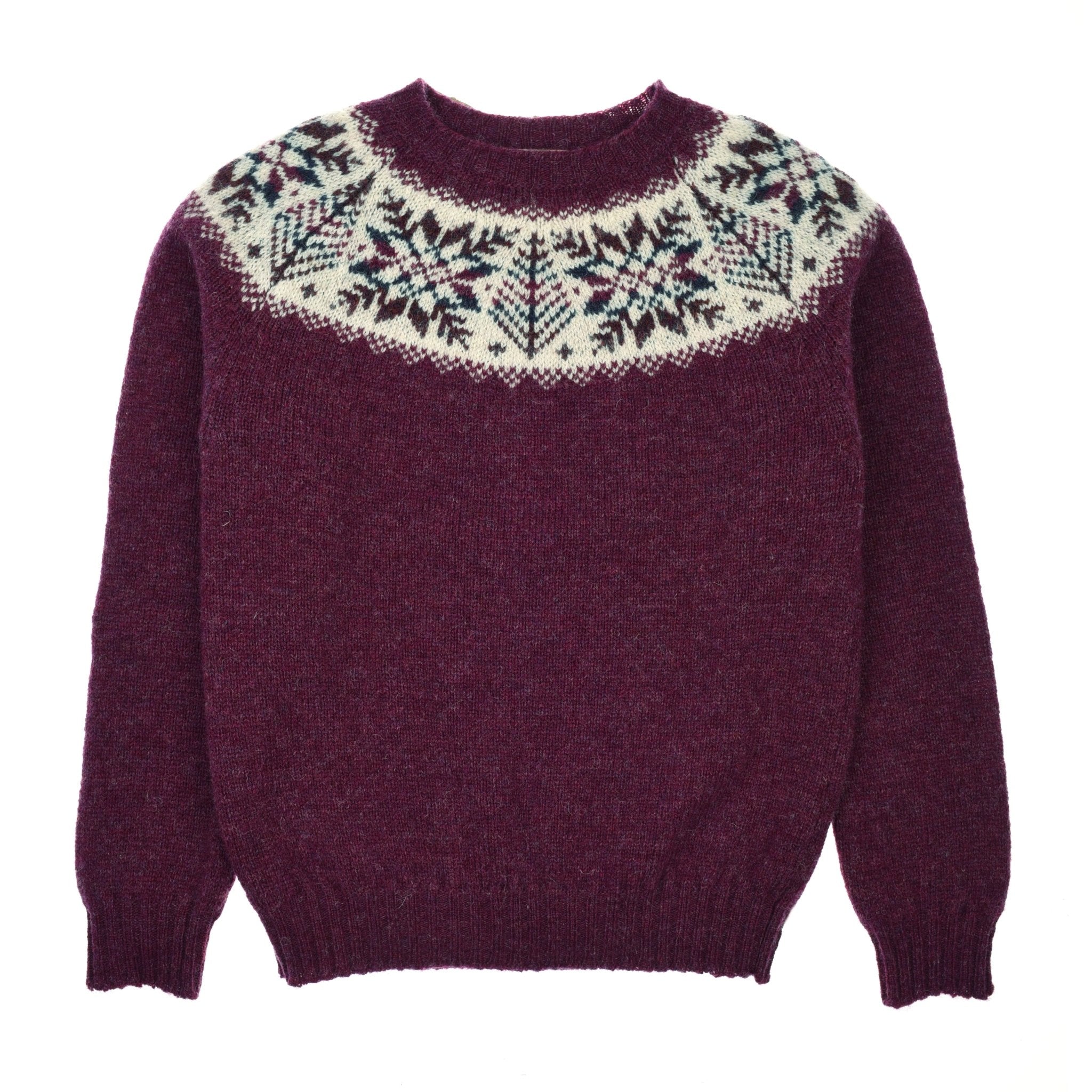 The Campbells of Beauly Shetland Wool Snowflake Crew Jumper in Berry features a white, green, and black Fairisle snowflake pattern around the neckline and shoulders, shown flat on a white background.