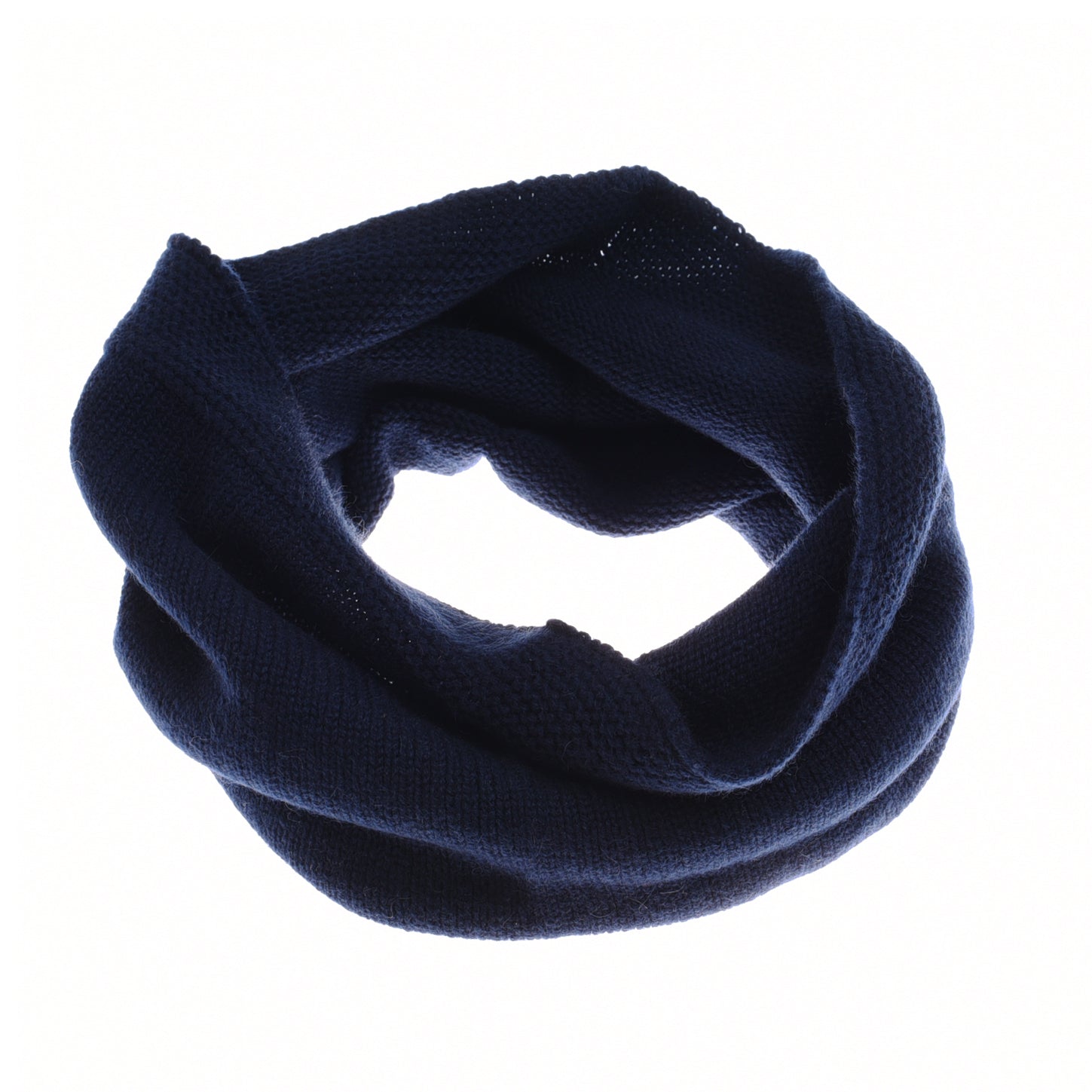 The Cashmere Snood by Campbells of Beauly is shown in a loop on a white background. Its dark navy hue and moss stitch texture highlight the scarf’s warmth and softness, while the infinity design offers a snug, stylish fit around the neck.