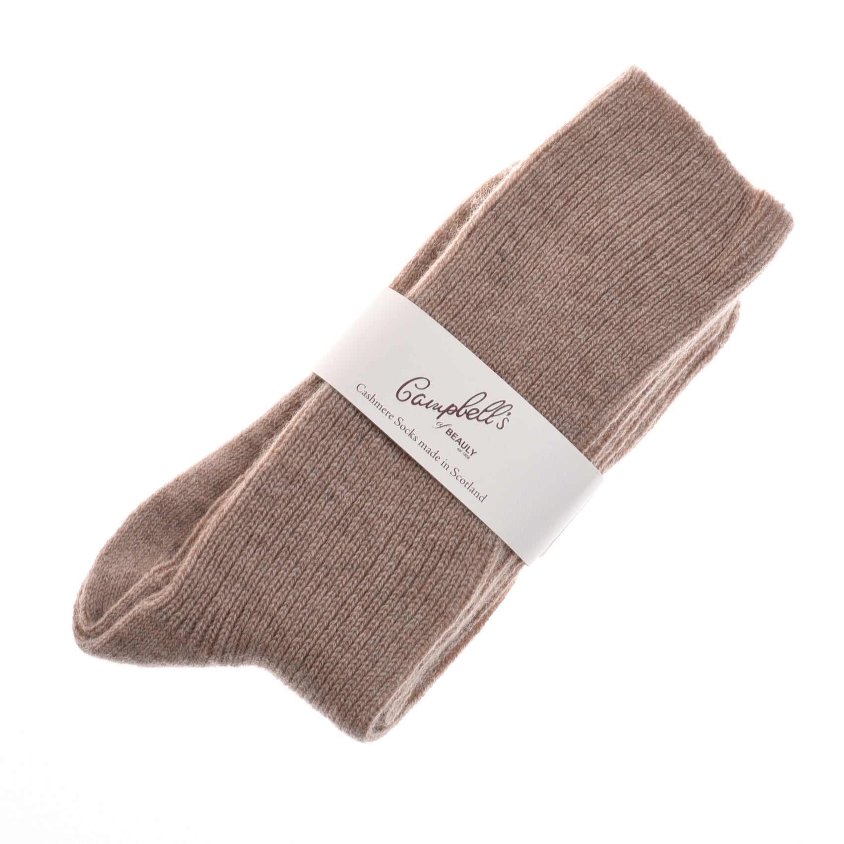 A pair of folded natural-colored Plain Cashmere Socks by Campbells of Beauly, wrapped with a white label featuring the brand and product details—a luxury gift inspired by the Scottish Borders tradition.