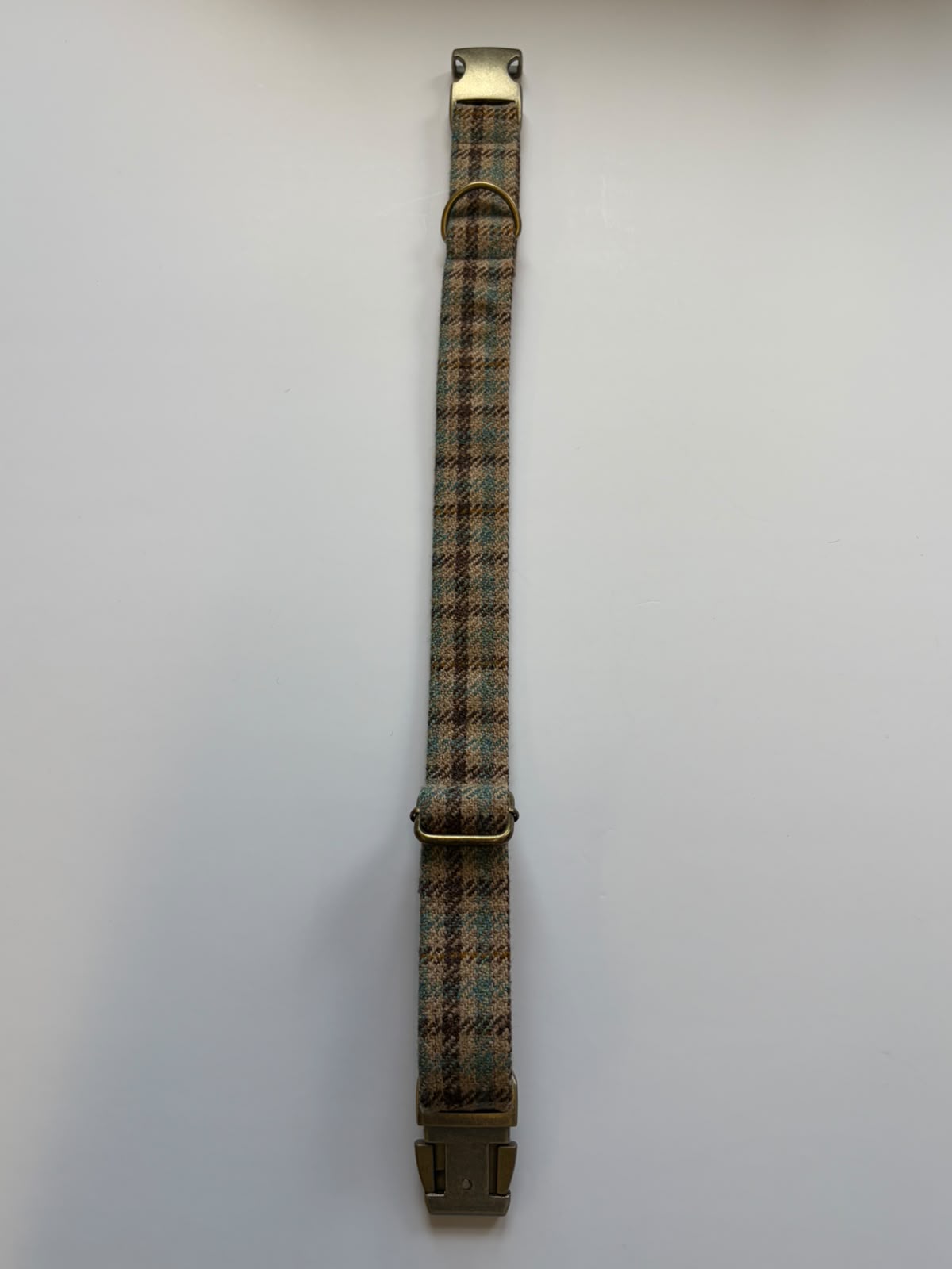 The House Tweed Dog Collar by Campbell's of Beauly is shown laid out flat on a white background, featuring a patterned fabric strap with metal clips at both ends and two metal loops in the center.
