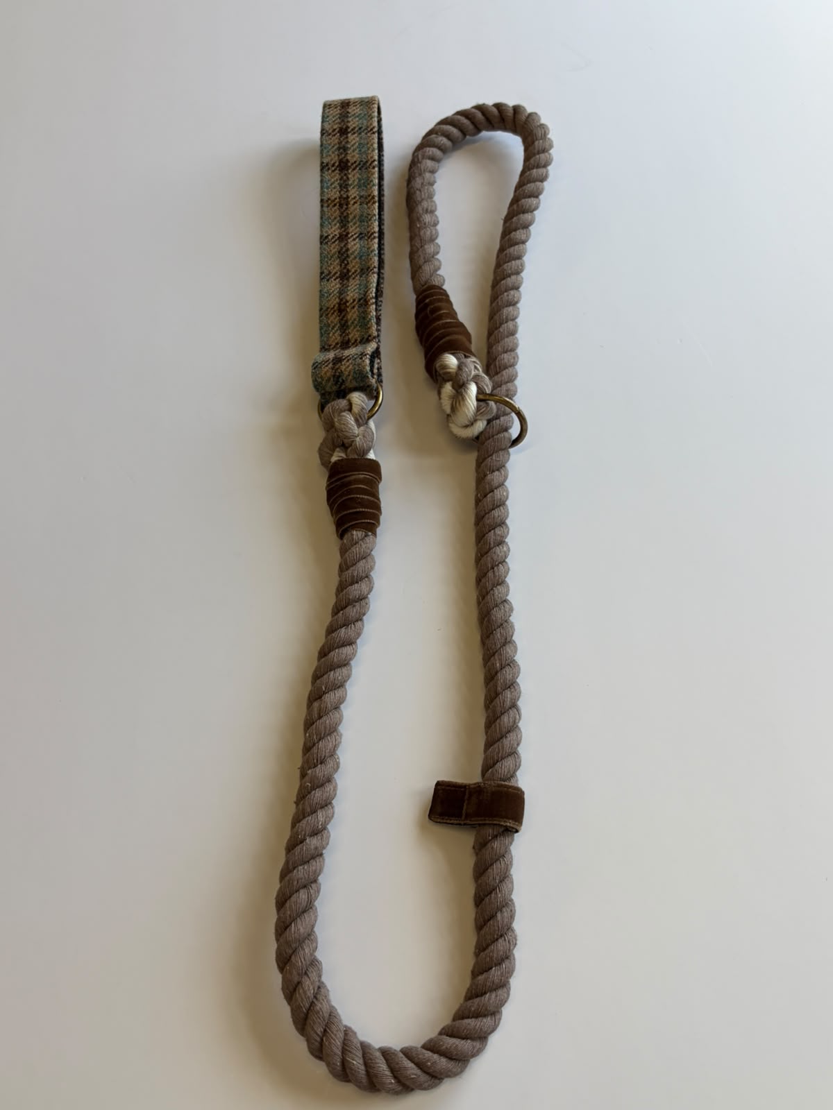 The House Tweed Slip Lead by Campbell's of Beauly—a twisted brown rope dog leash featuring a plaid fabric handle and metal ring—is displayed on a white surface.