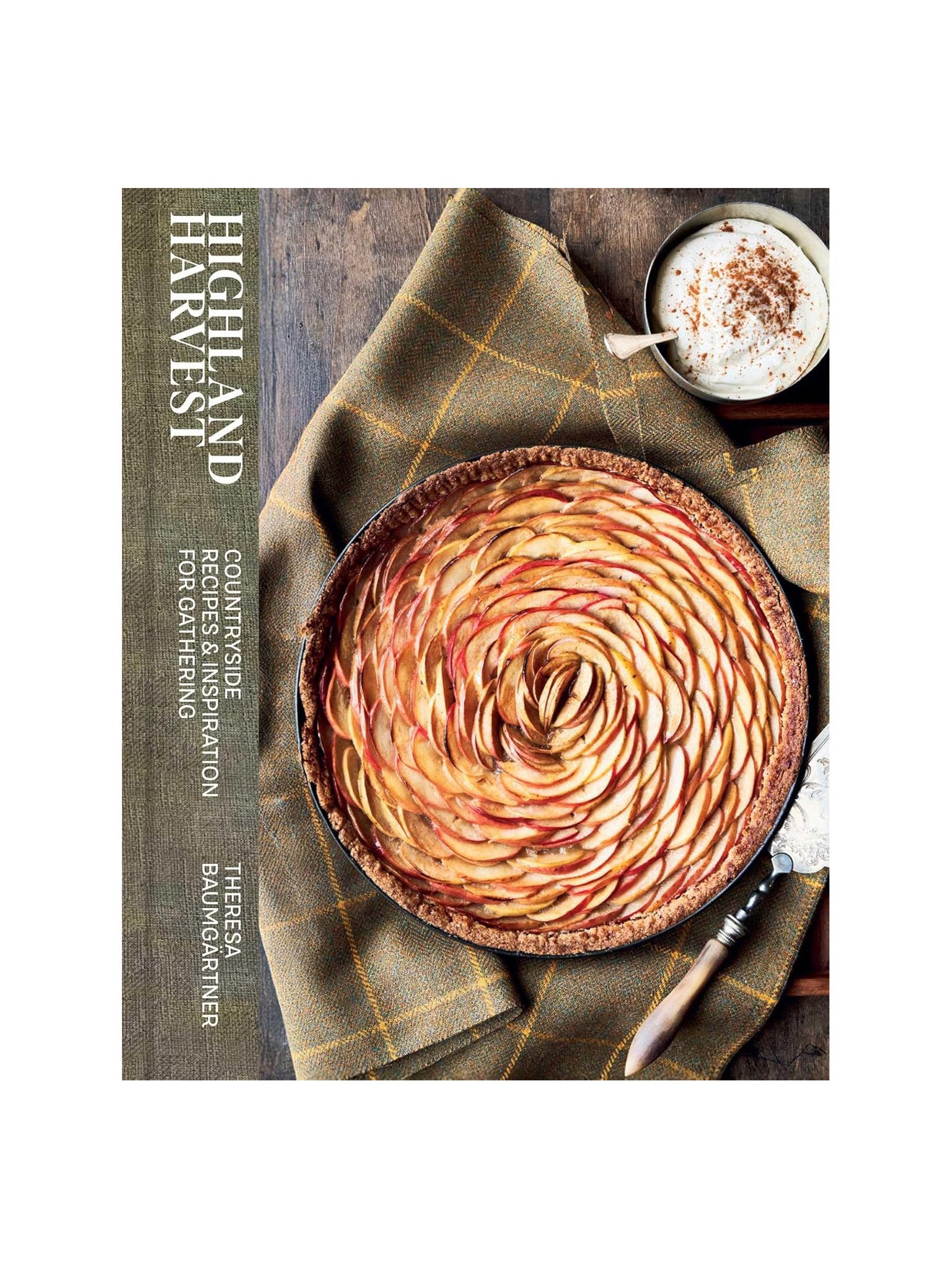A rustic apple tart sits on a plaid cloth next to whipped cream with cinnamon, while the Campbell's of Beauly Highland Harvest Book is displayed on the left.