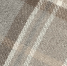 Close-up of a soft Scottish Cashmere Stole by Campbell's of Beauly, featuring a plaid pattern in gray, beige, and white. Intersecting lines form classic squares and rectangles, giving this stole a timeless, cozy look.