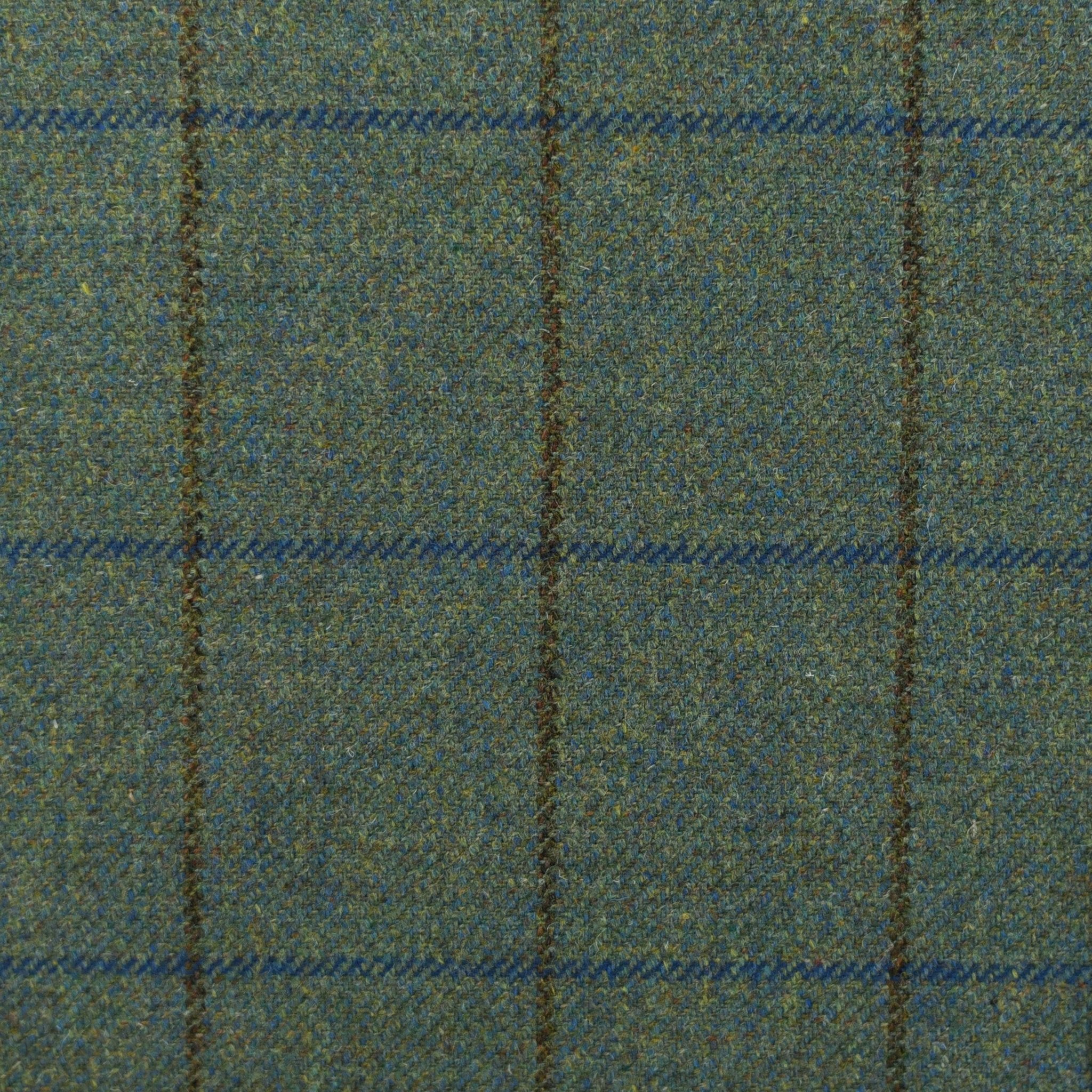 House Tweed 81759 by Campbells of Beauly features green tweed with a woven grid of brown and blue lines. Made in the Scottish Borders, this traditional Saxony tweed has a slightly coarse texture and classic, understated style.