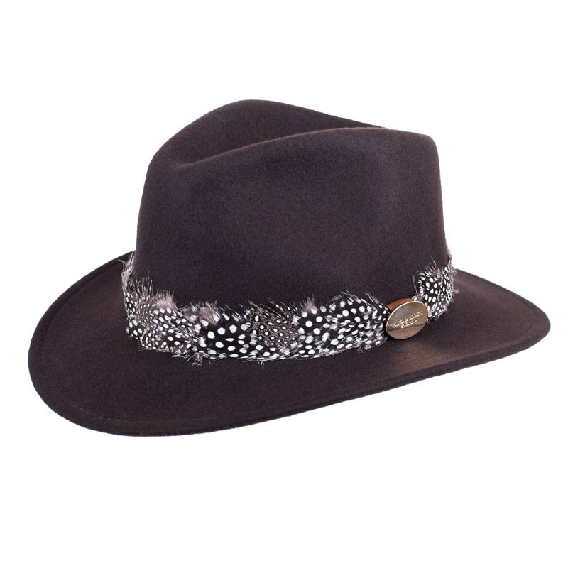 The Hicks & Brown Guinea Feather Maroon Fedora is a brown wool felt hat with a wide brim, featuring a black and white spotted guinea feather band and a round metallic side emblem.