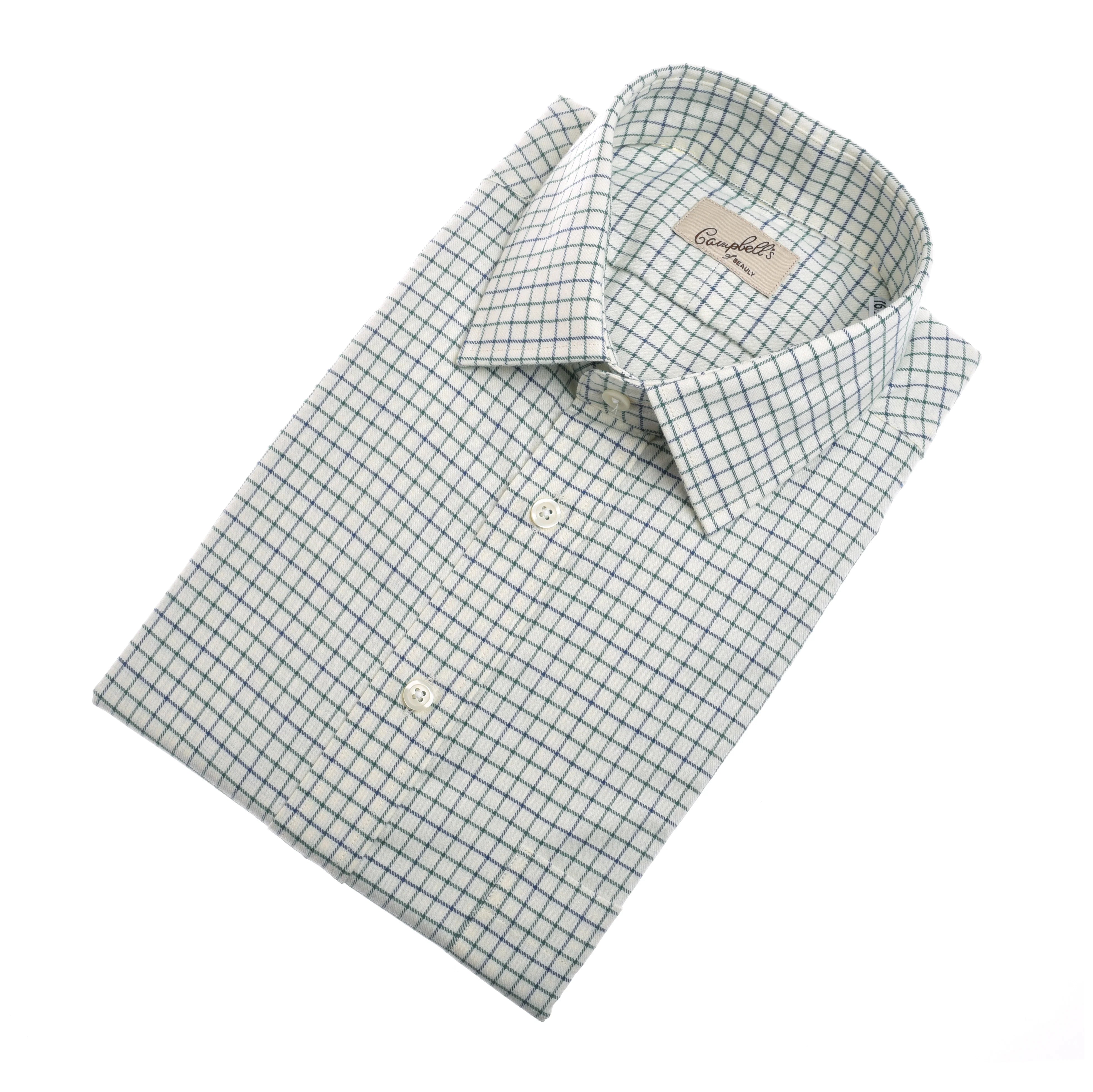 A neatly folded Campbell’s of Beauly Windowpane Shirt in white with a blue and green grid pattern, buttoned up and showing the label inside the collar.
