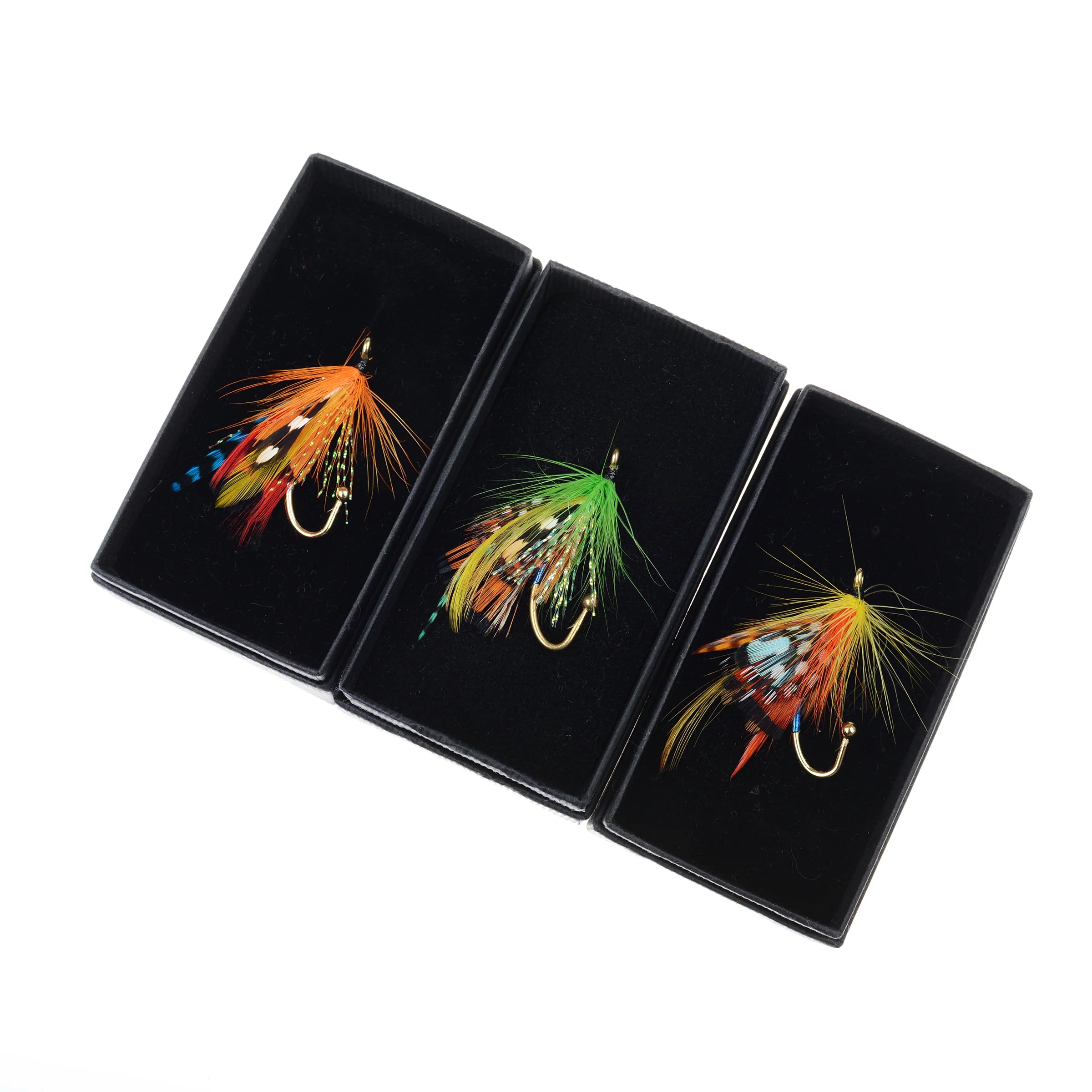 Campbell's of Beauly Fly Fishing Brooch: Three colorful handmade brooches—orange, green, and yellow—each featuring feathers and hooks, are individually displayed in black boxes against a white background.