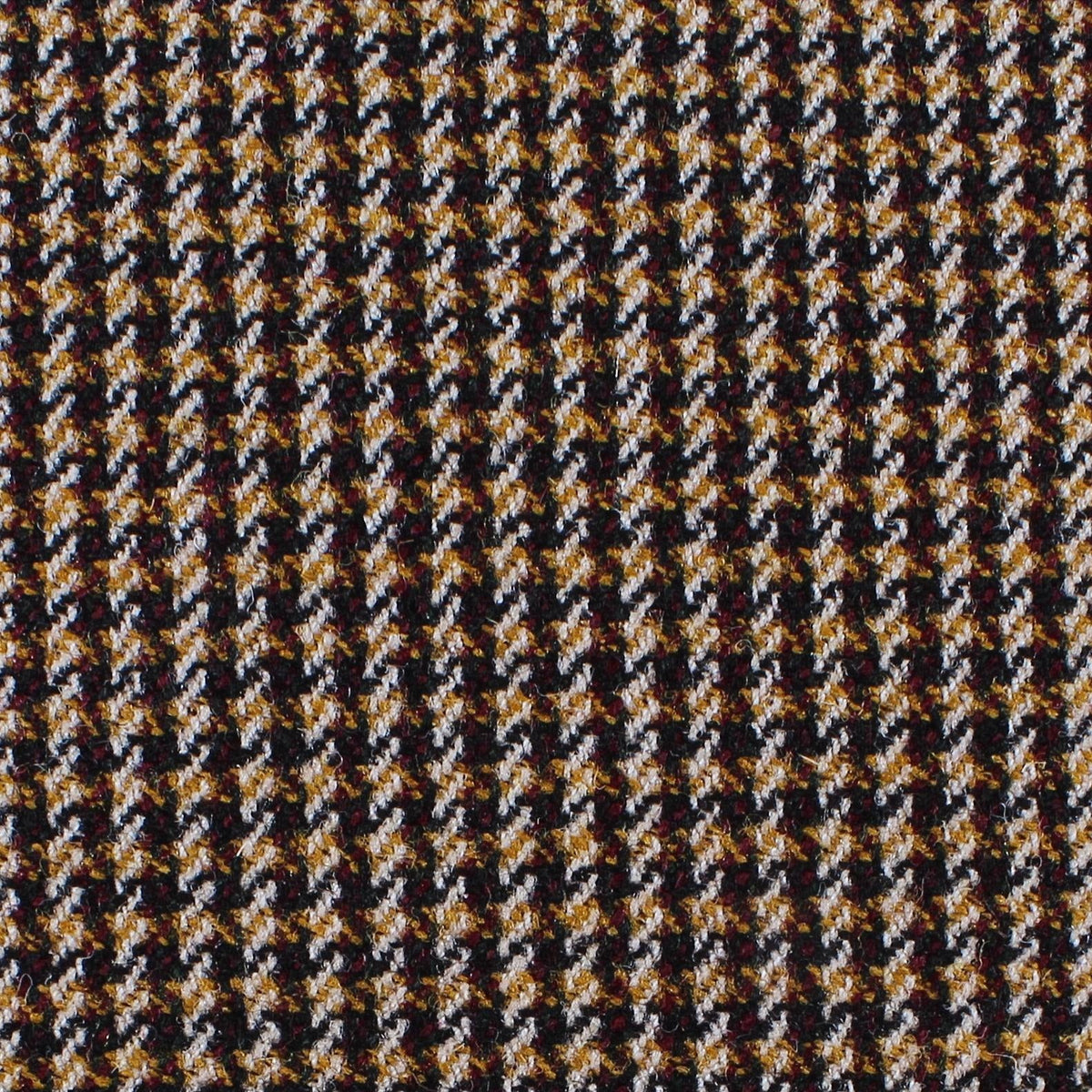 Estate Tweed 005 heavyweight sporting cloth in a black, white, and golden-brown houndstooth pattern.