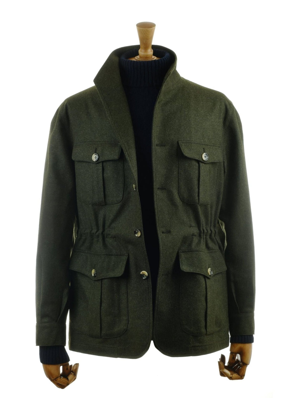 The Campbell’s of Beauly Field Teba Jacket, crafted from olive green Austrian loden wool and featuring four front pockets with button closures, is shown on a wooden mannequin layered over a dark sweater against a plain white background.