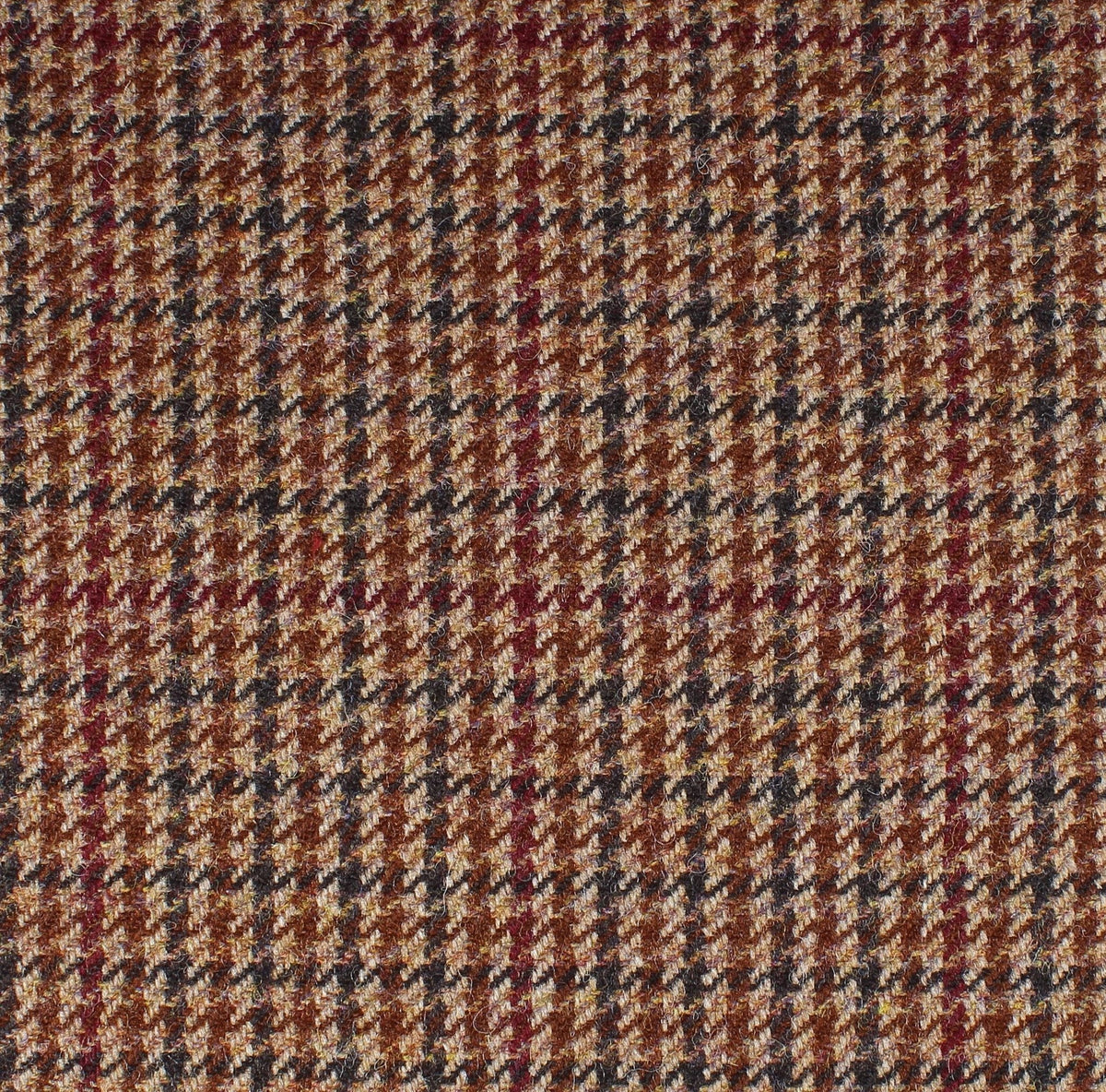 Field Tweed 134 in brown and tan Scottish tweed, featuring a houndstooth pattern with thin vertical red stripes.