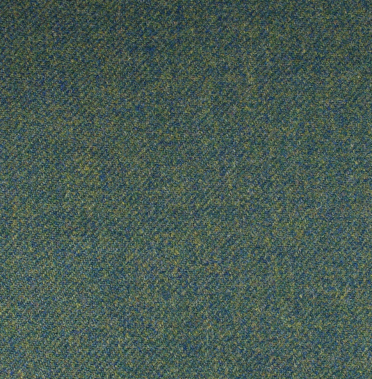 A close-up of Field Tweed 137, a dark green and blue Scottish tweed fabric featuring a subtle herringbone pattern.